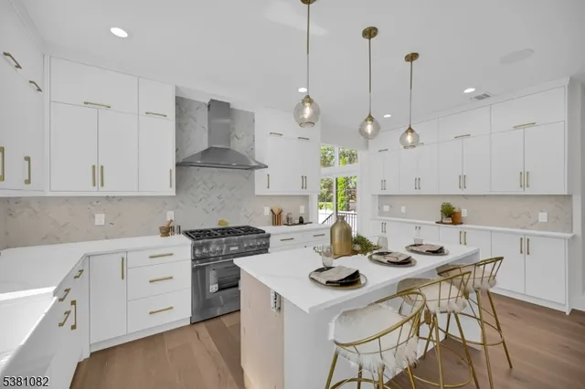 a kitchen with a stove a white table and chairs