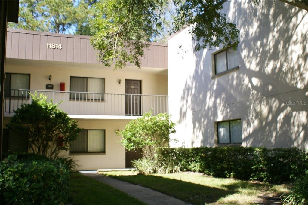 11814 Raintree Lake Lane, Unit D Temple Terrace, FL 33617 - Photo 1 of 1 a front view of a house with a yard and garage