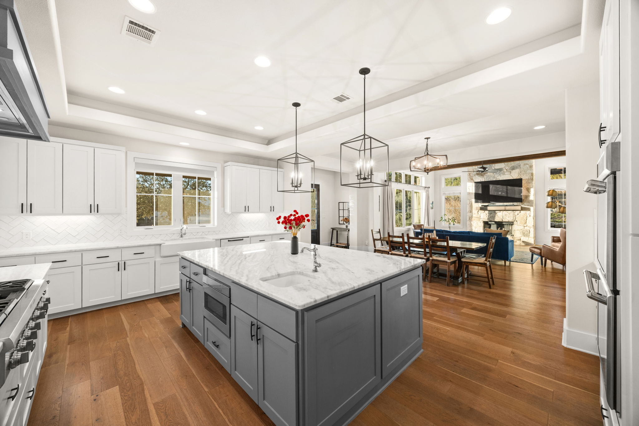 7809 Brandy Way Volente, TX 78641 - Photo 11 of 40 a kitchen with center island wooden floor center island and appliances