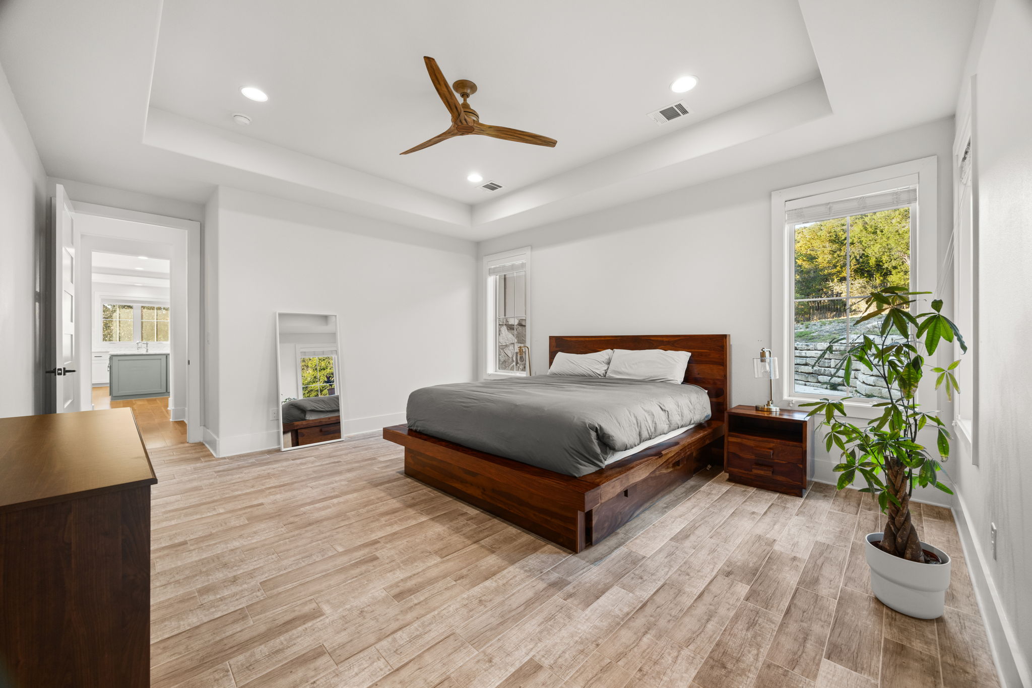 7809 Brandy Way Volente, TX 78641 - Photo 14 of 40 a bedroom with a large bed and a potted plant