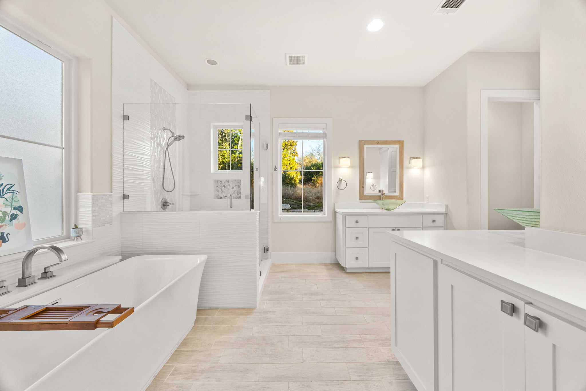 7809 Brandy Way Volente, TX 78641 - Photo 15 of 40 a bathroom with a tub sink and mirror
