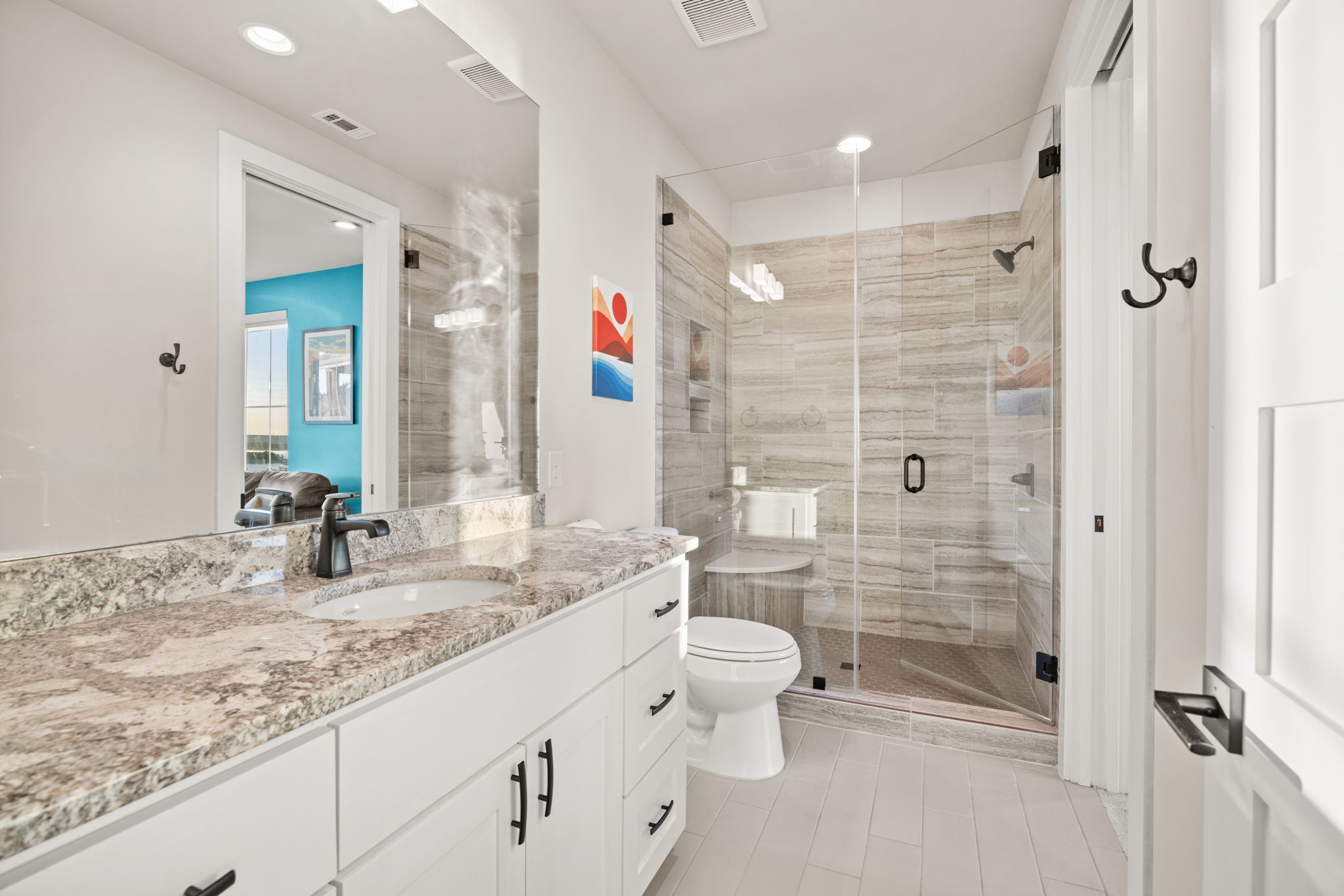 7809 Brandy Way Volente, TX 78641 - Photo 24 of 40 a bathroom with a granite countertop sink mirror vanity and toilet
