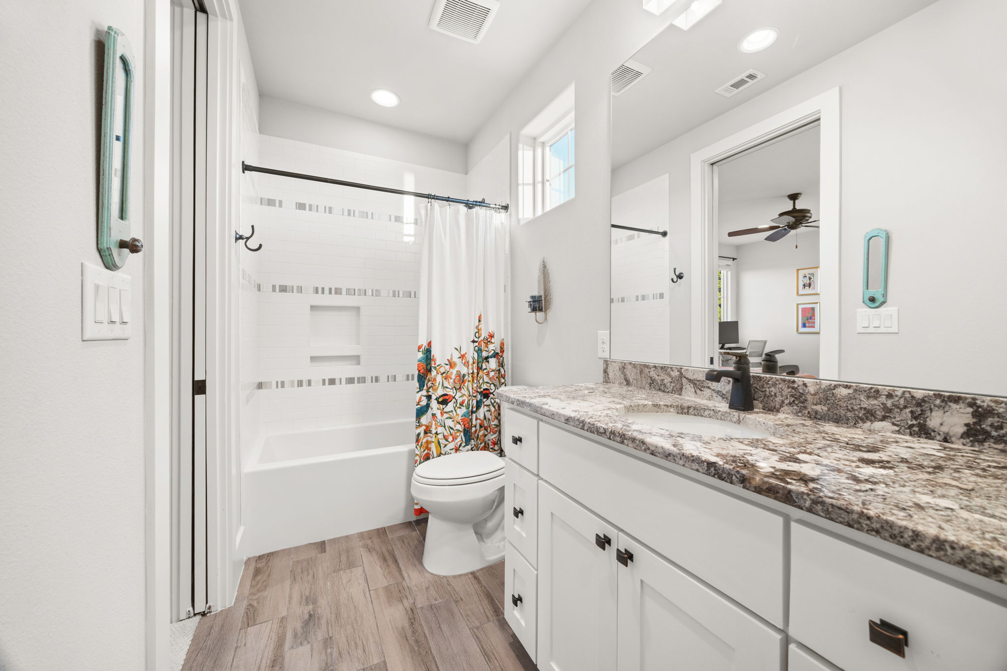 7809 Brandy Way Volente, TX 78641 - Photo 27 of 40 a bathroom with a granite countertop sink toilet and shower