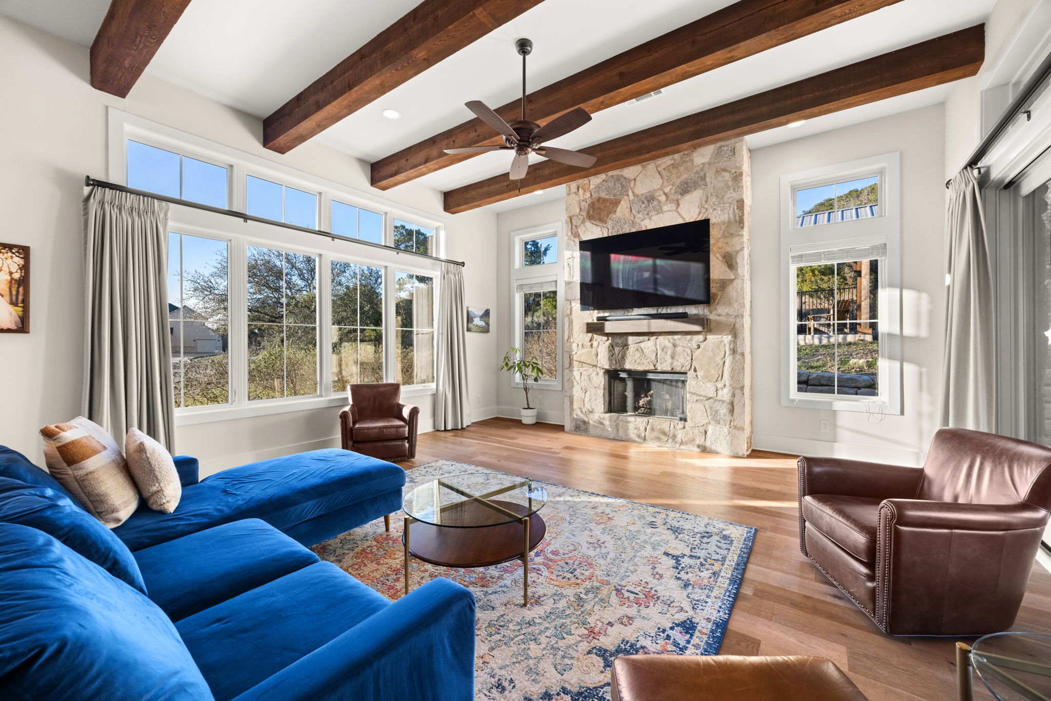 7809 Brandy Way Volente, TX 78641 - Photo 6 of 40 a living room with furniture a flat screen tv and a fireplace