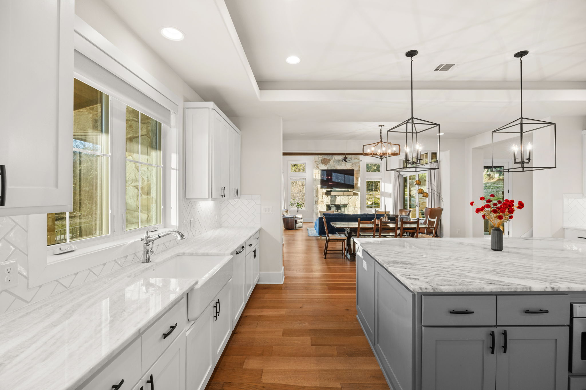 7809 Brandy Way Volente, TX 78641 - Photo 10 of 40 a large kitchen with kitchen island lots of counter space windows and a chandelier