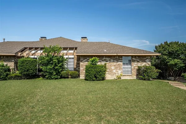 a view of a house with garden and yard
