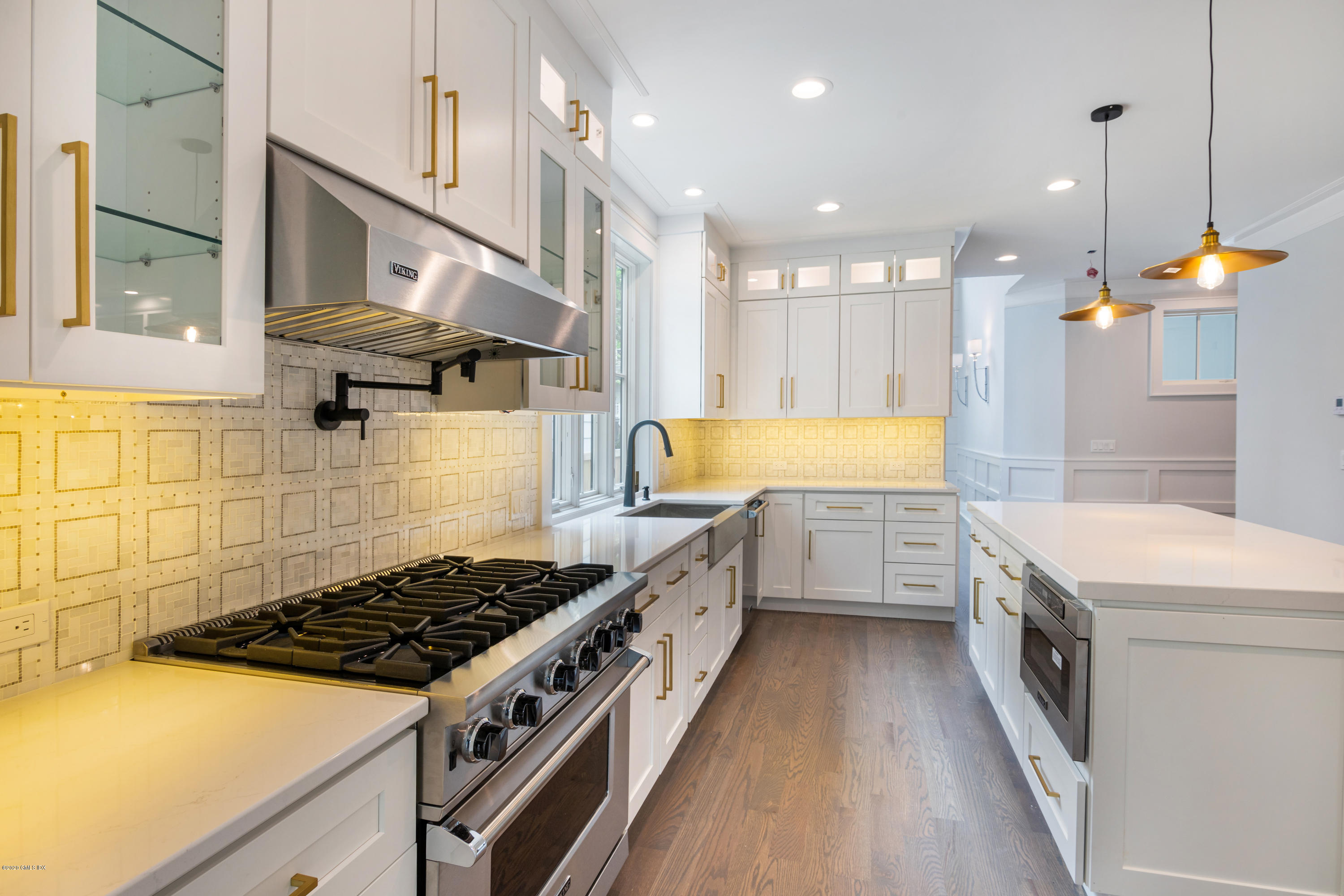 38 Cassidy Street, Unit 38 Greenwich, CT 06830 - Photo 11 of 50 a kitchen with stainless steel appliances granite countertop a lot of cabinets and wooden floor