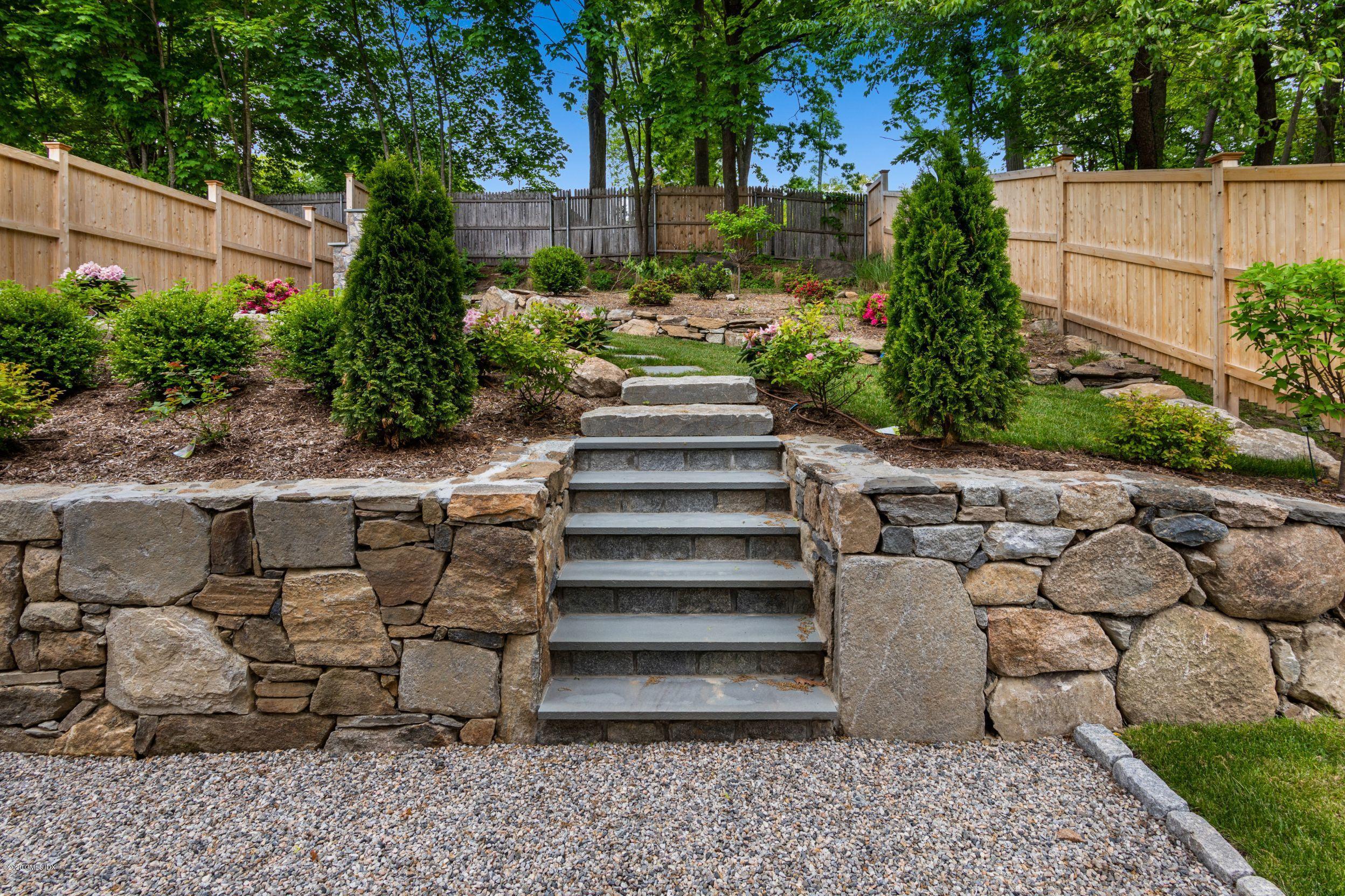 38 Cassidy Street, Unit 38 Greenwich, CT 06830 - Photo 18 of 50 a view of a house with a yard plants and a fountain