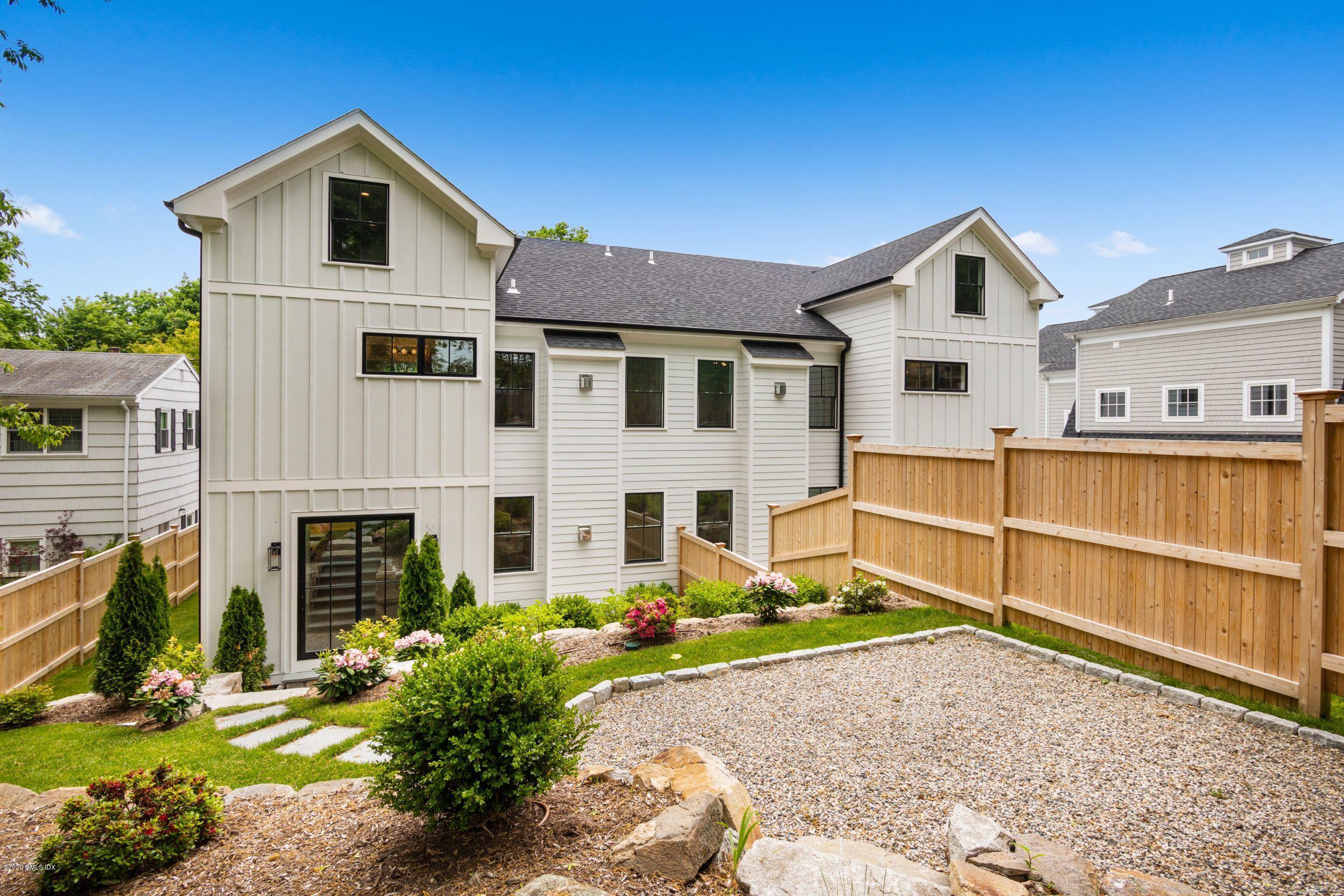 38 Cassidy Street, Unit 38 Greenwich, CT 06830 - Photo 20 of 50 a front view of a house with a yard