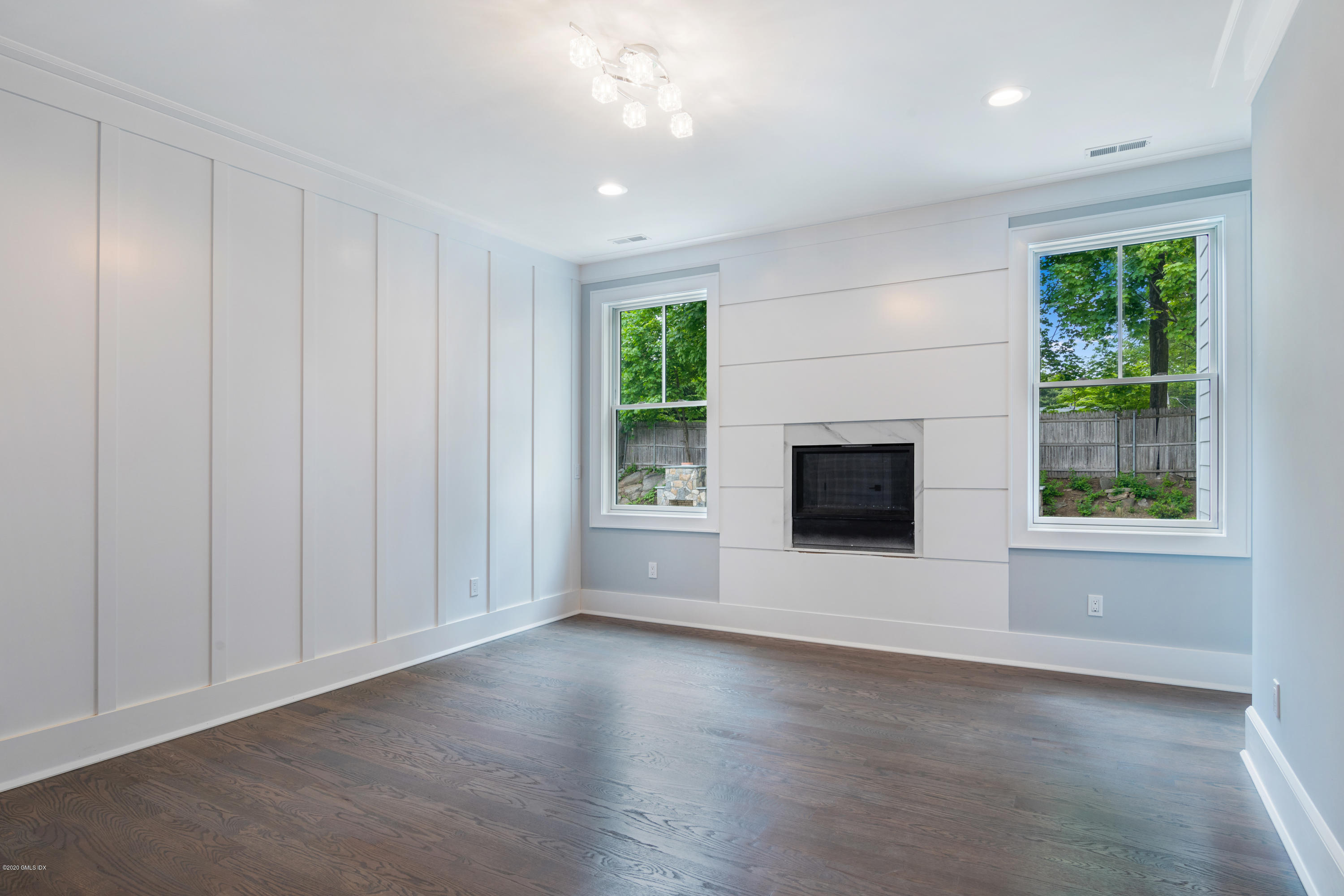 38 Cassidy Street, Unit 38 Greenwich, CT 06830 - Photo 22 of 50 an empty room with windows and fireplace