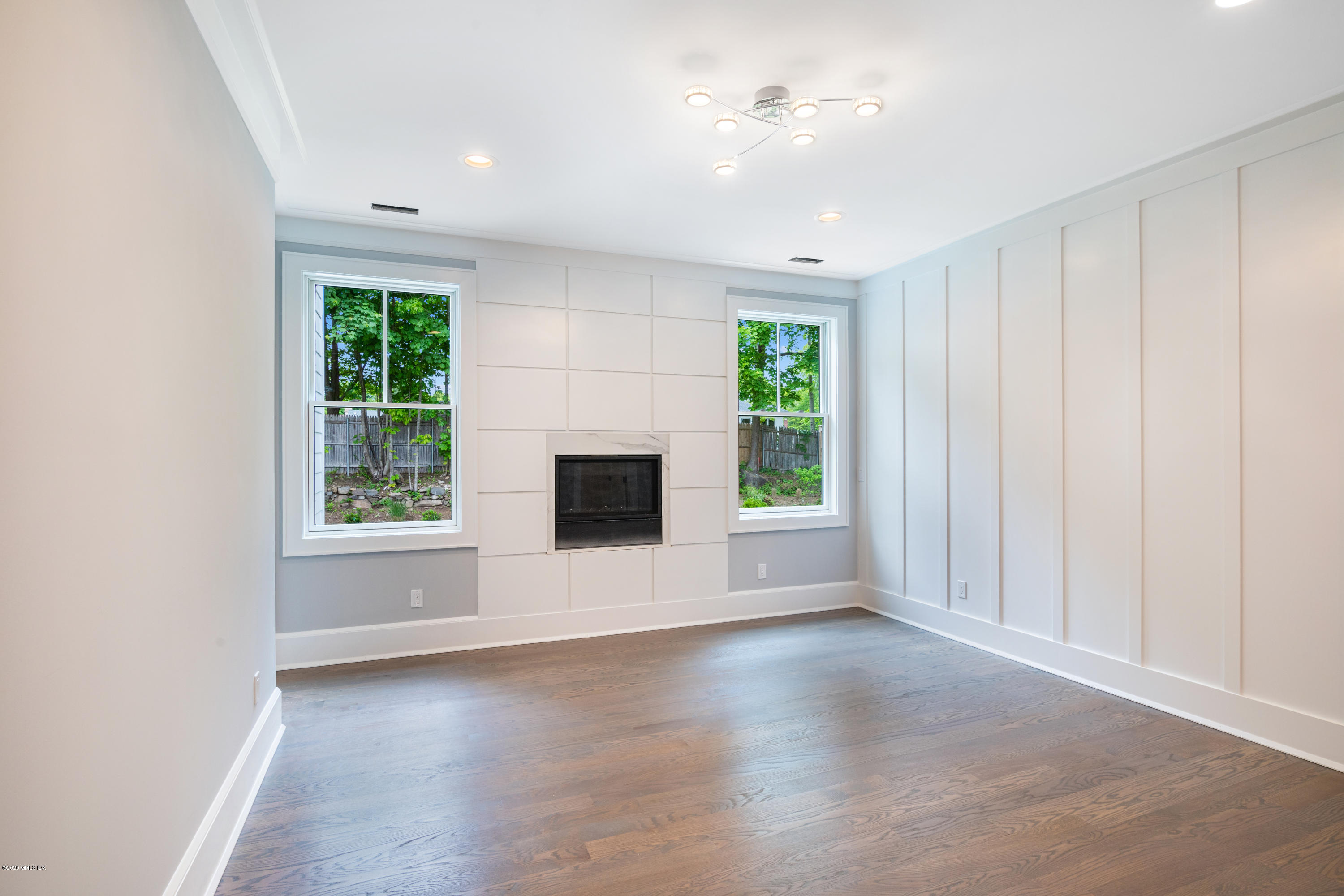 38 Cassidy Street, Unit 38 Greenwich, CT 06830 - Photo 23 of 50 an empty room with windows and fireplace