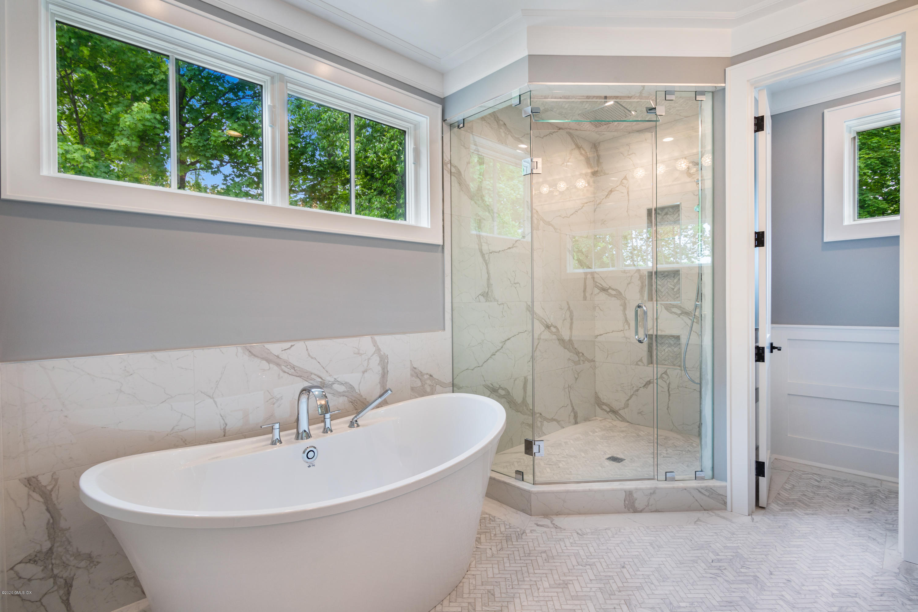 38 Cassidy Street, Unit 38 Greenwich, CT 06830 - Photo 24 of 50 a white bath tub sitting under a bathroom mirror