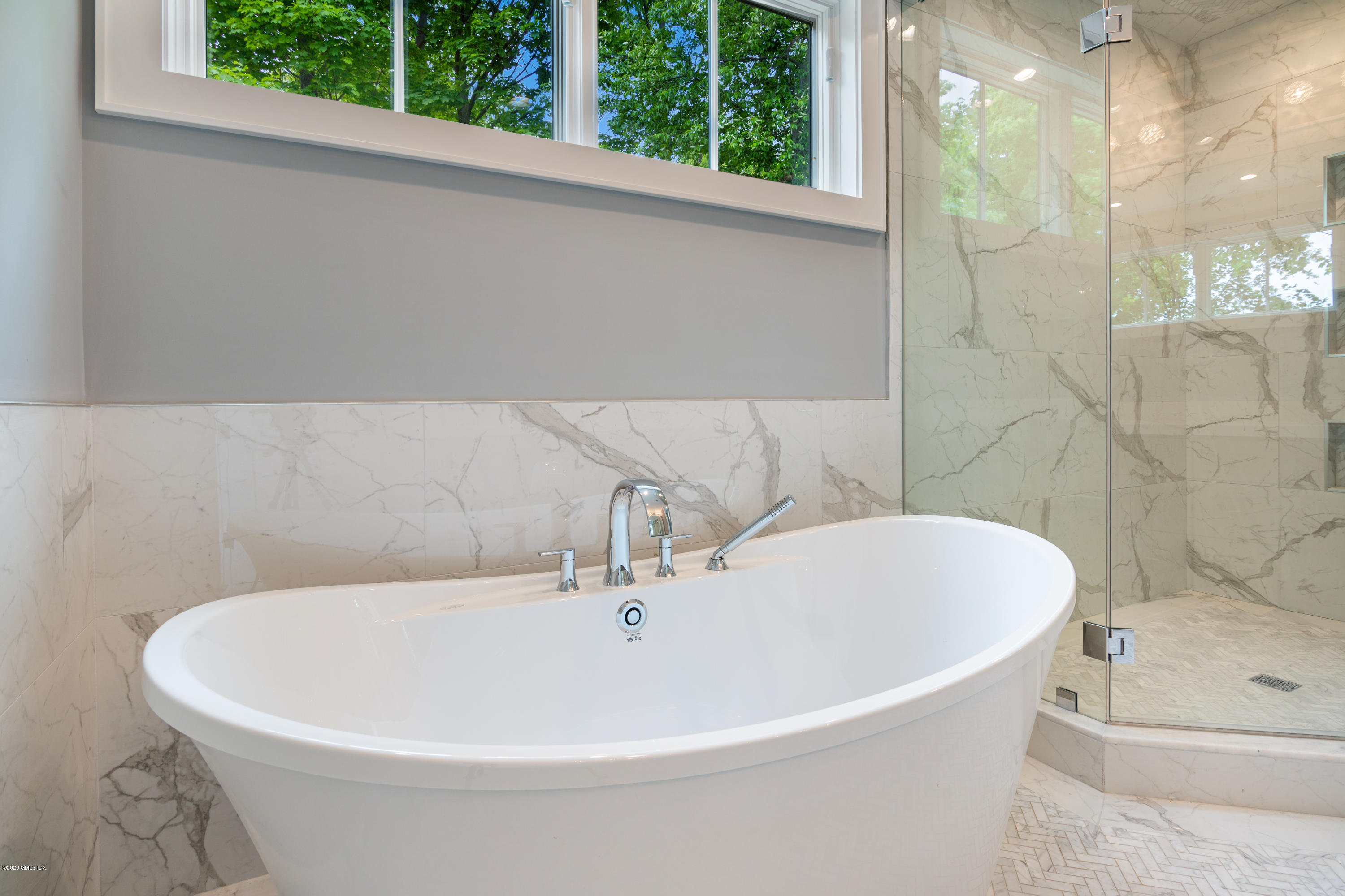 38 Cassidy Street, Unit 38 Greenwich, CT 06830 - Photo 25 of 50 a white bath tub sitting in a bathroom next to a window
