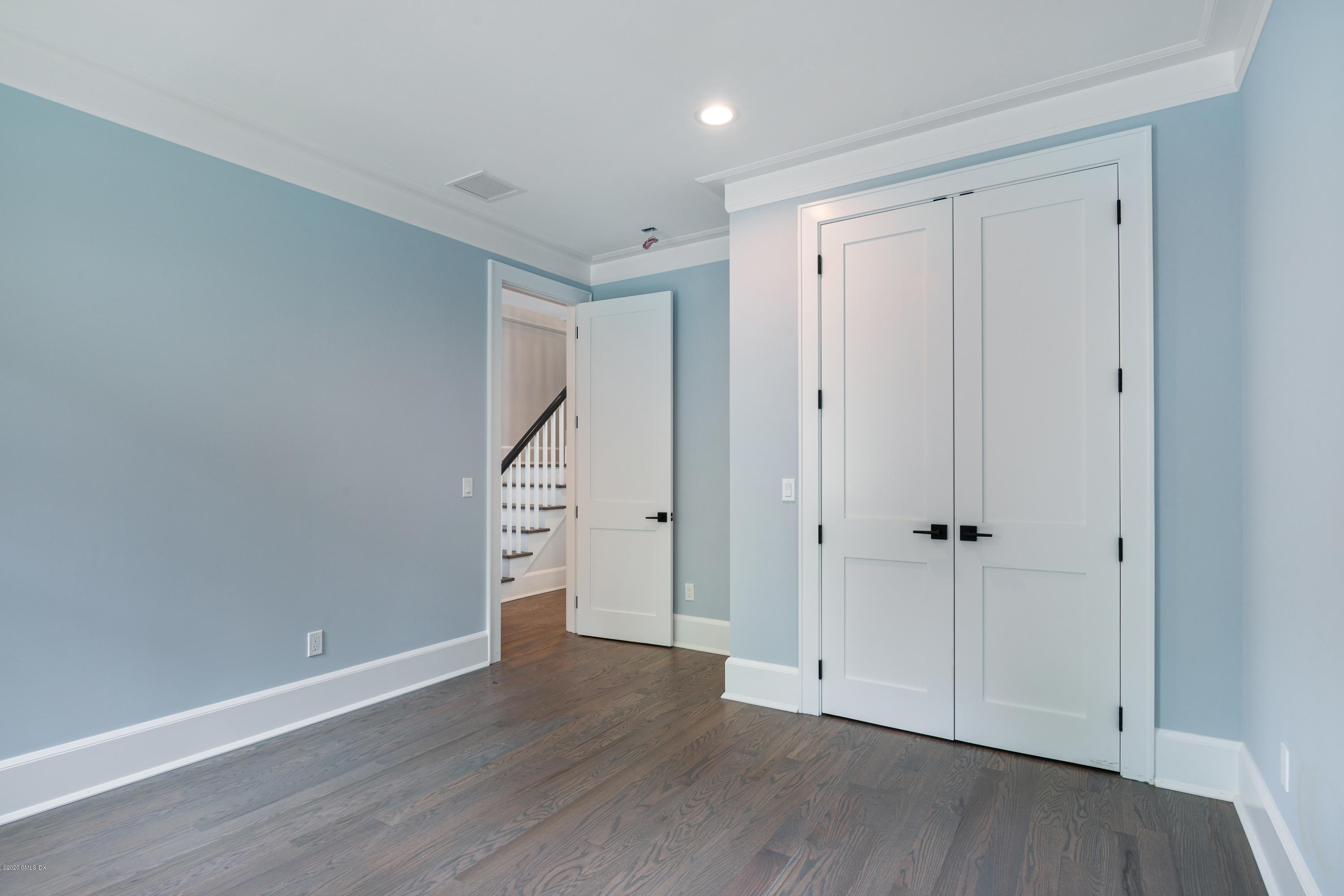 38 Cassidy Street, Unit 38 Greenwich, CT 06830 - Photo 31 of 50 a view of an empty room with wooden floor and entryway