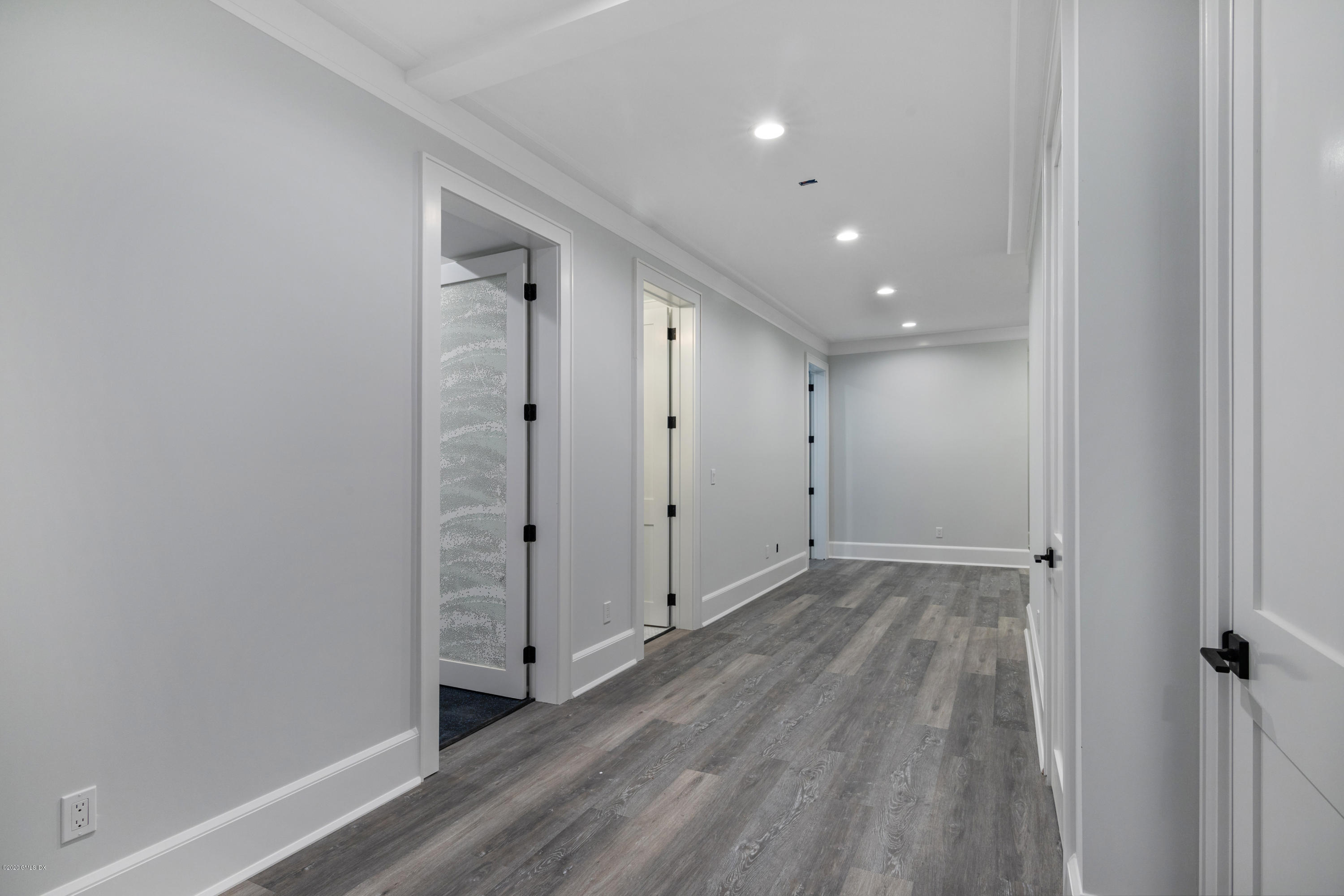 38 Cassidy Street, Unit 38 Greenwich, CT 06830 - Photo 40 of 50 a view of a hallway with wooden floor and a hallway