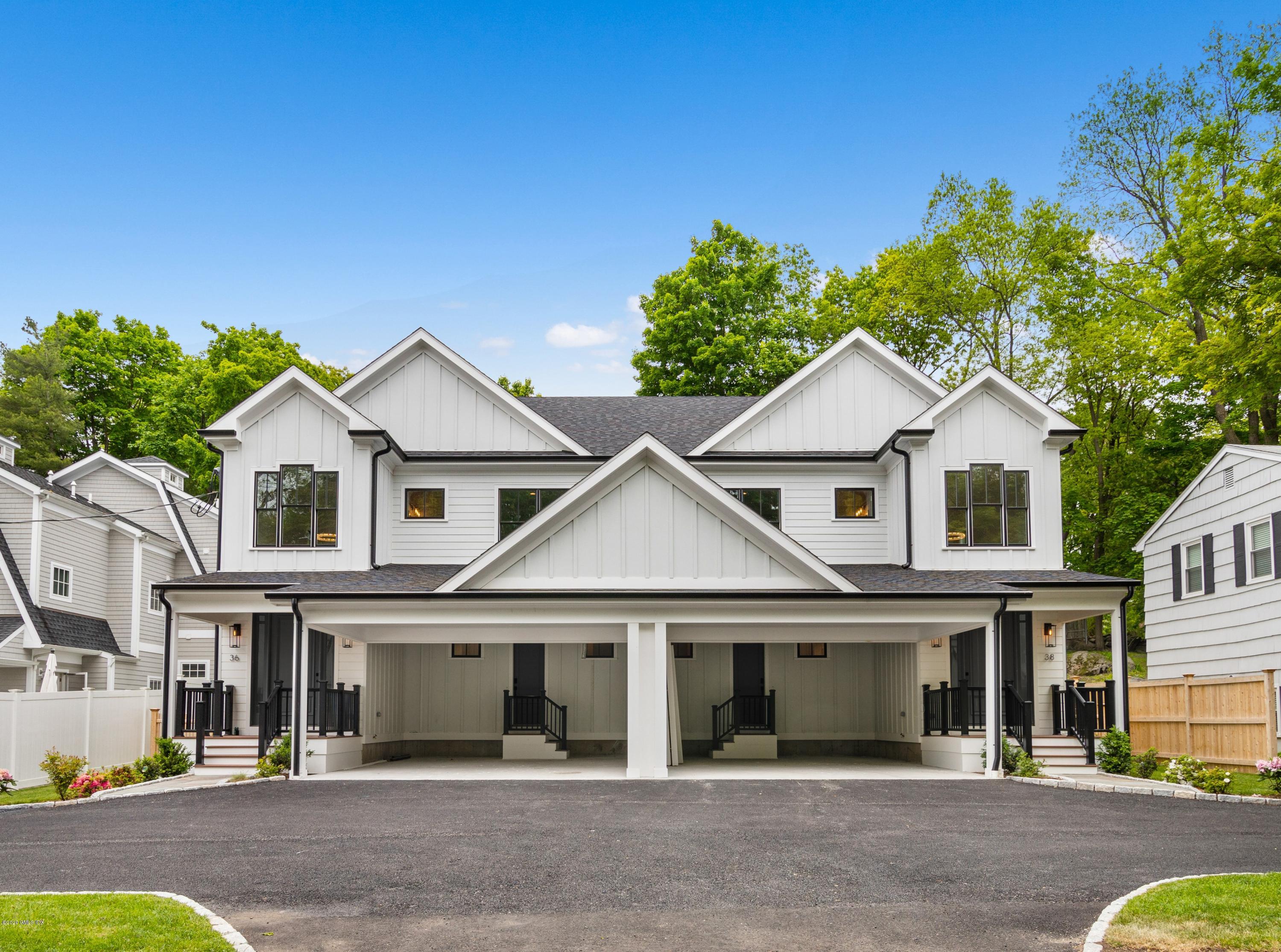 38 Cassidy Street, Unit 38 Greenwich, CT 06830 - Photo 7 of 50 a white house with a large windows plants and palm trees