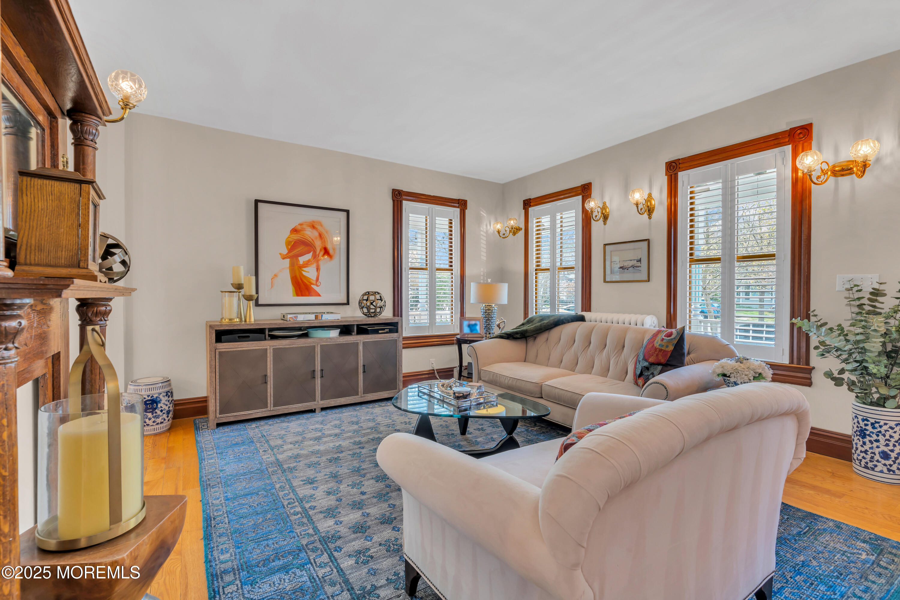 44 Irving Place Red Bank, NJ 07701 - Photo 15 of 74 a living room with furniture a flat screen tv and a floor to ceiling window