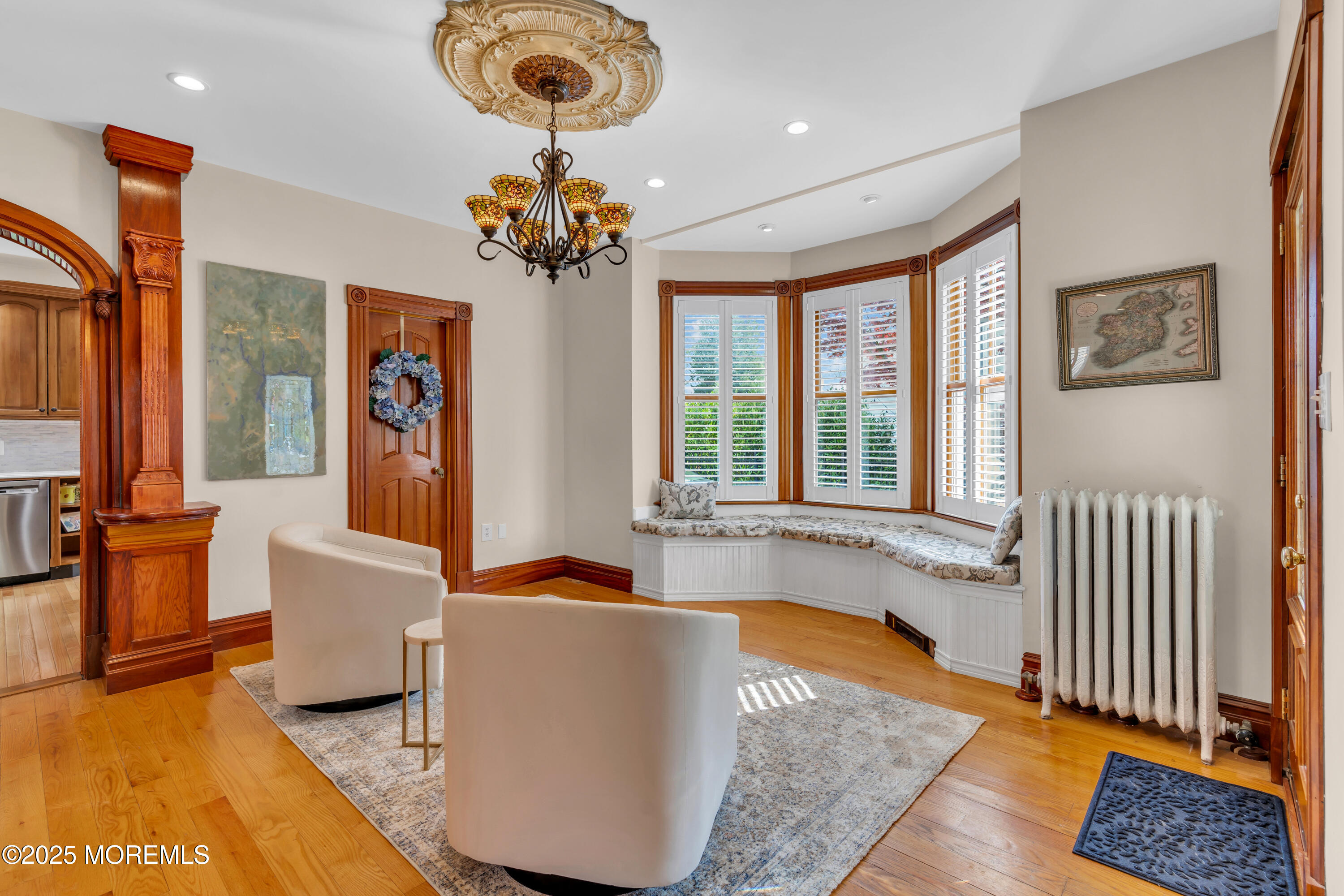 44 Irving Place Red Bank, NJ 07701 - Photo 21 of 74 a living room with a couch and a chandelier