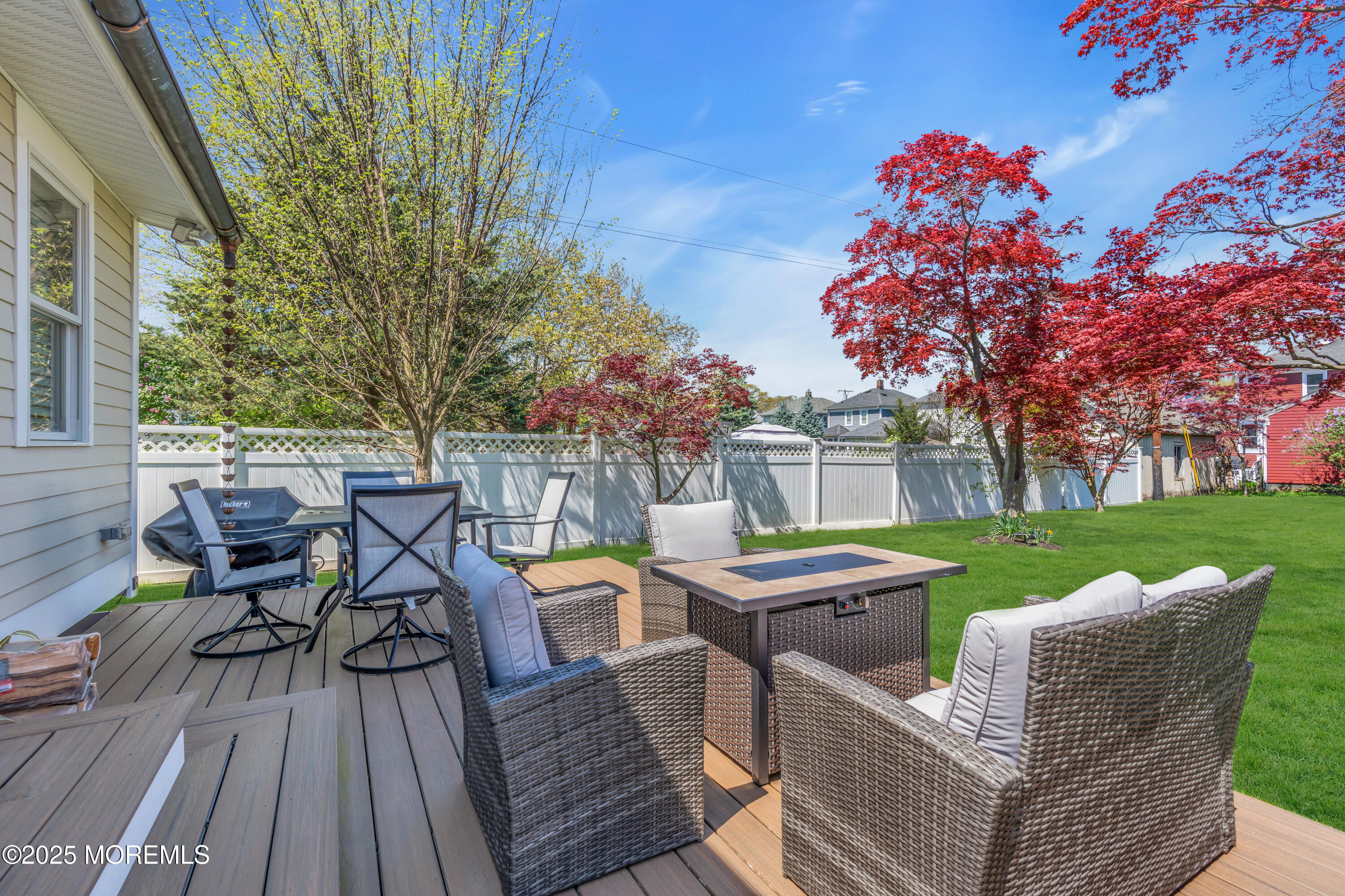 44 Irving Place Red Bank, NJ 07701 - Photo 52 of 74 a view of a patio with table and chairs and potted plants with wooden floor and fence