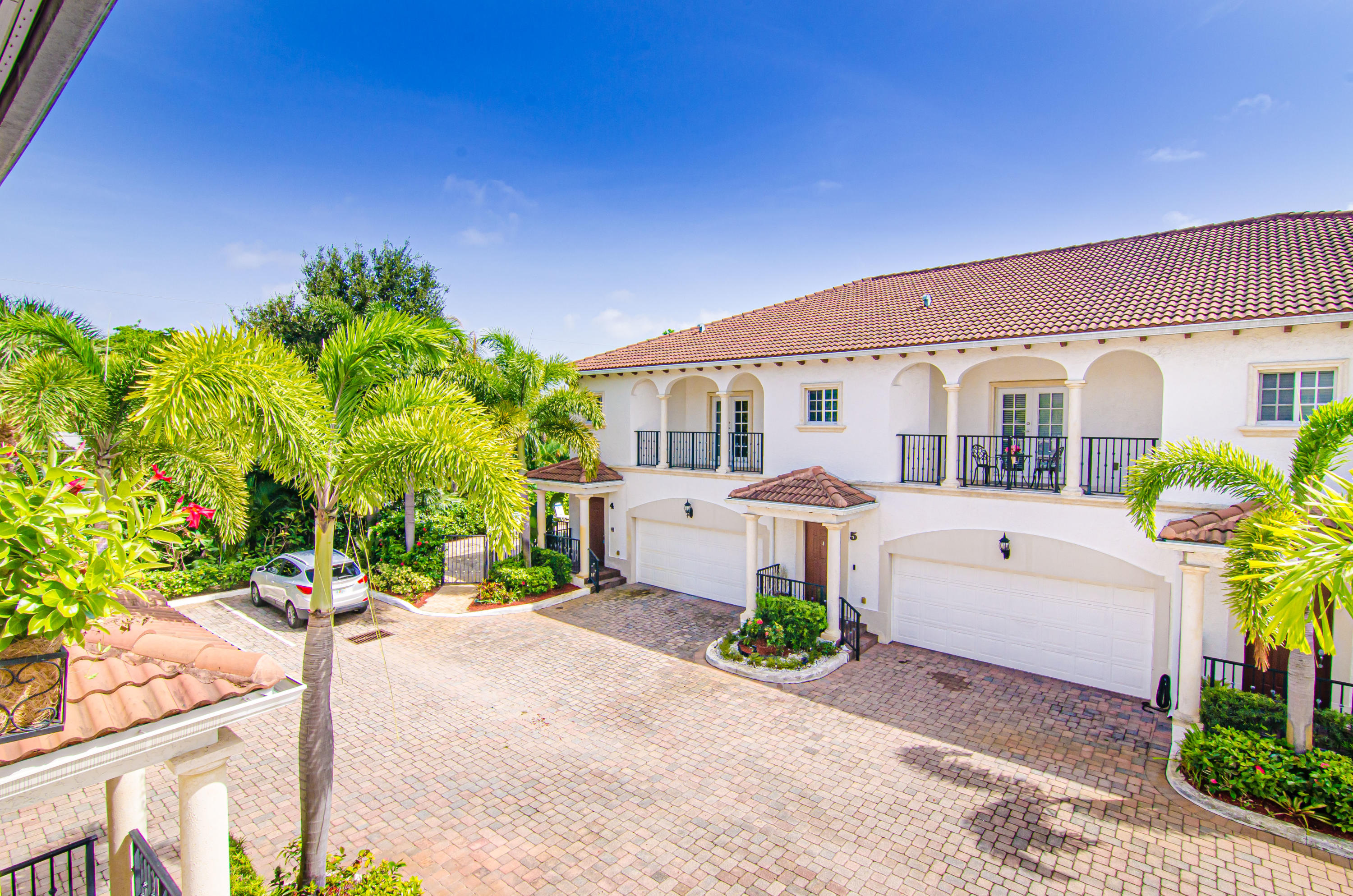816 Prosperity Farms Road, Unit 2 North Palm Beach, FL 33408 - Photo 16 of 30 a front view of a house with a yard and a garden