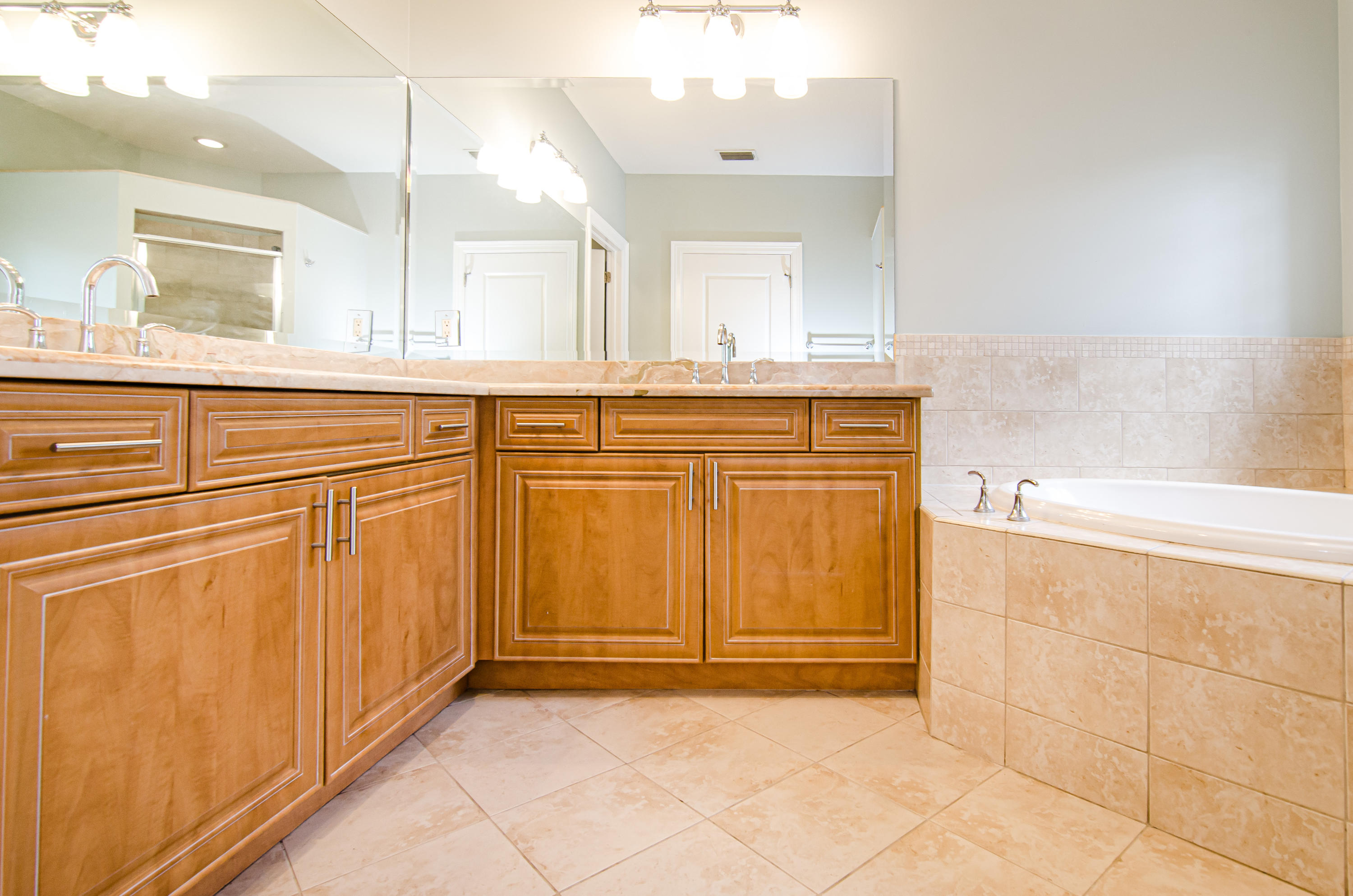 816 Prosperity Farms Road, Unit 2 North Palm Beach, FL 33408 - Photo 20 of 30 a bathroom with a sink a mirror and a bathtub