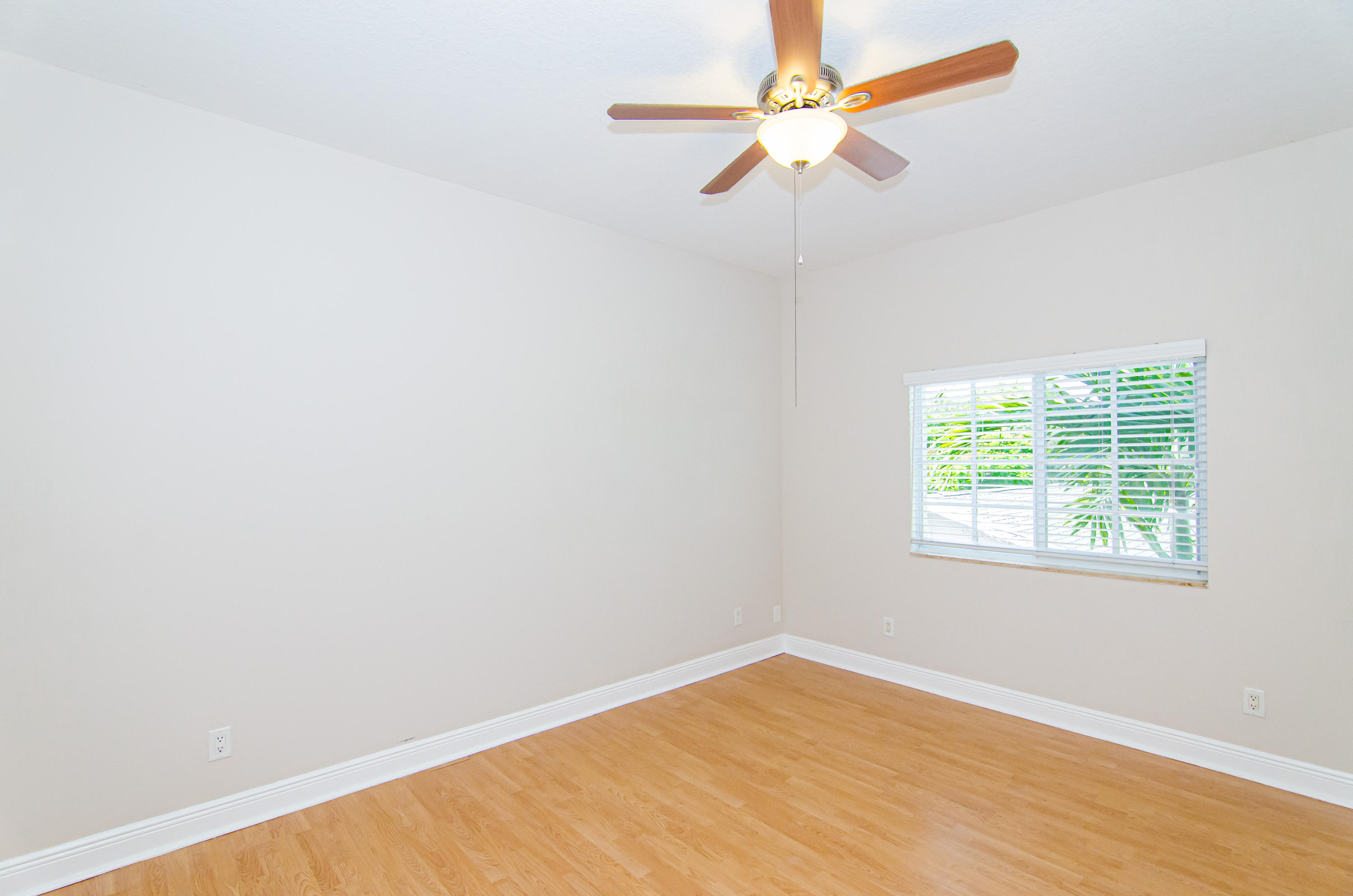 816 Prosperity Farms Road, Unit 2 North Palm Beach, FL 33408 - Photo 26 of 30 an empty room with a window and a fan