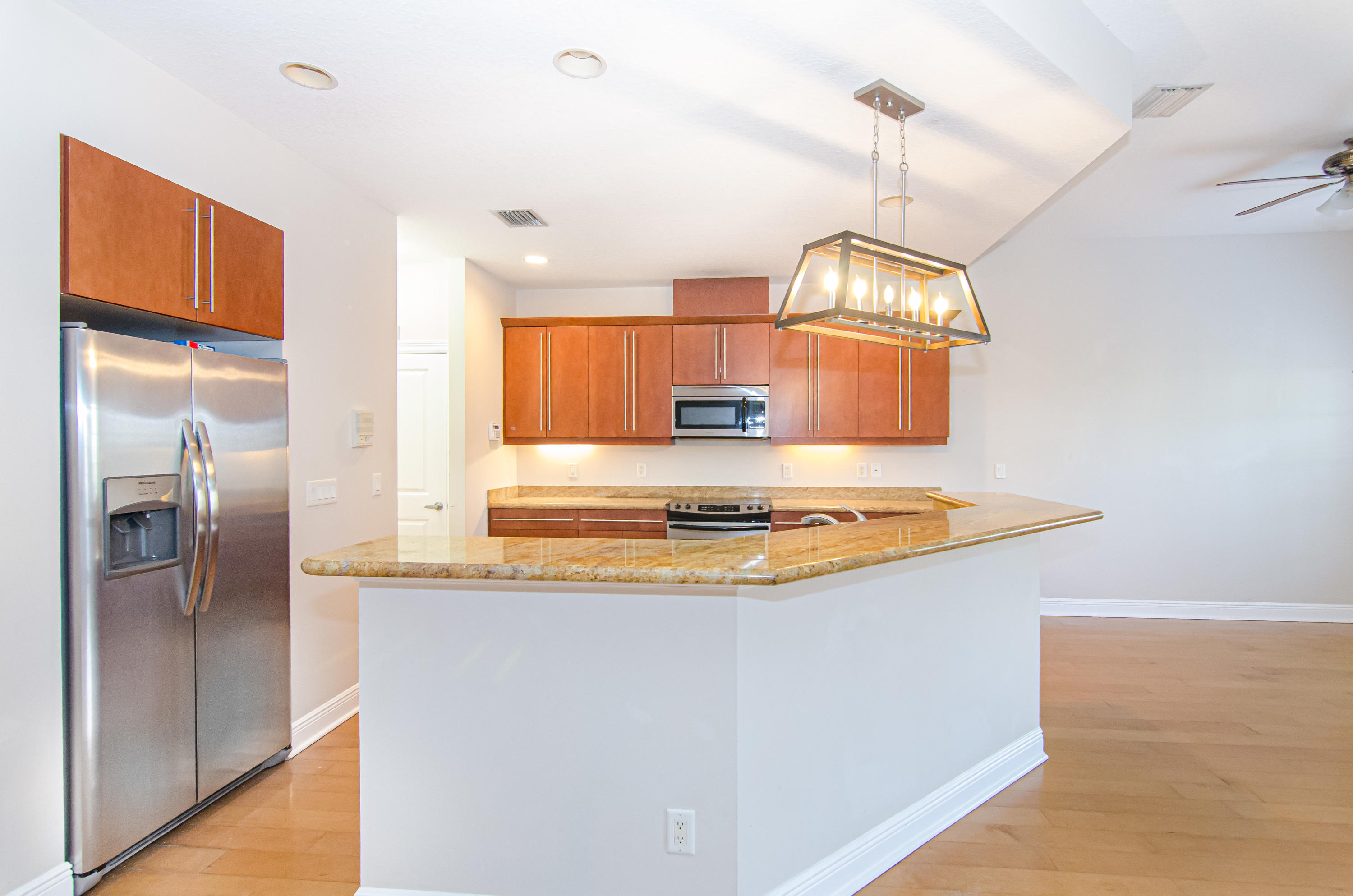 816 Prosperity Farms Road, Unit 2 North Palm Beach, FL 33408 - Photo 3 of 30 a view of a kitchen with a sink and refrigerator