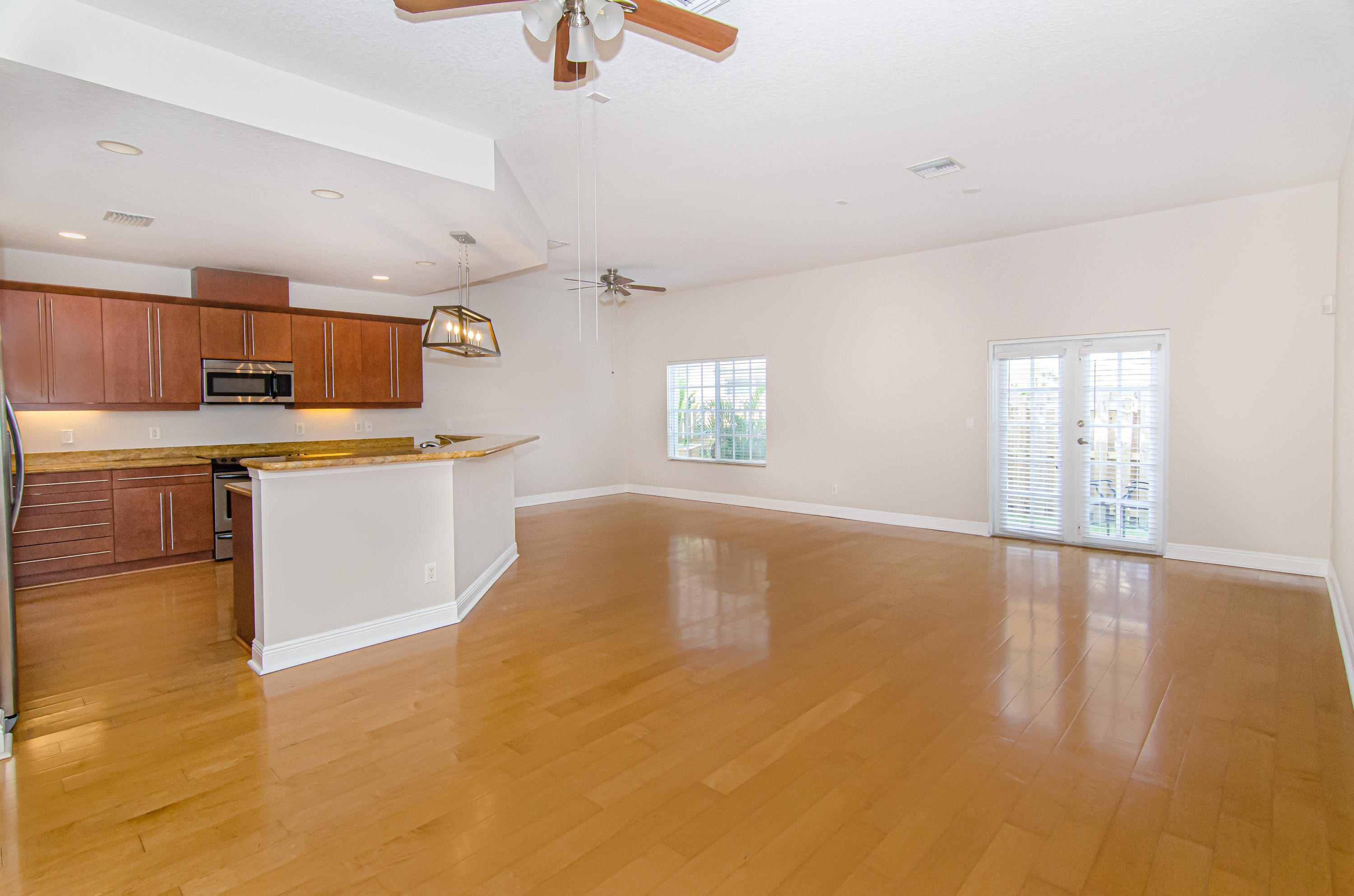 816 Prosperity Farms Road, Unit 2 North Palm Beach, FL 33408 - Photo 5 of 30 a kitchen with stainless steel appliances a stove a sink white cabinets and a refrigerator