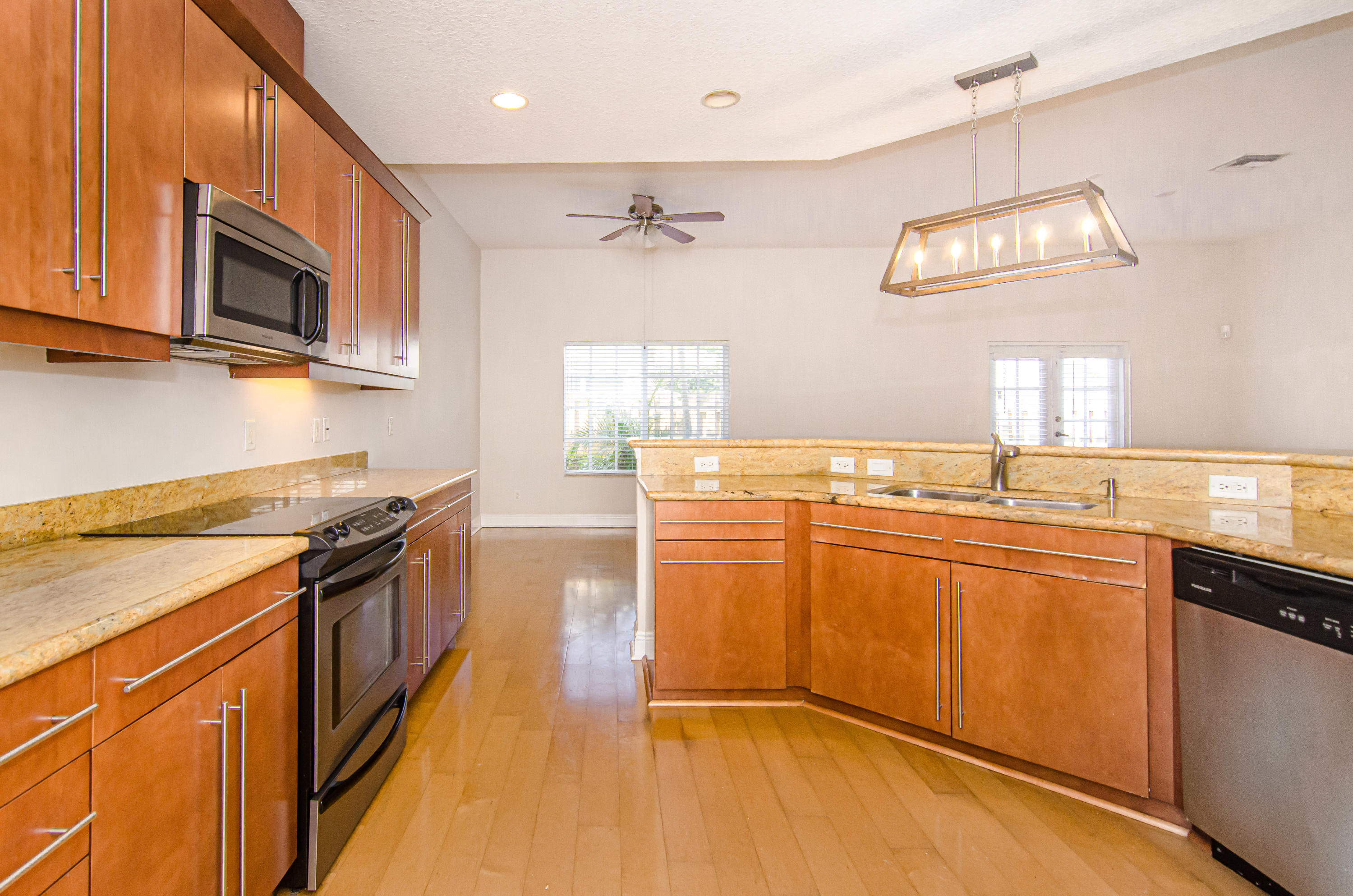 816 Prosperity Farms Road, Unit 2 North Palm Beach, FL 33408 - Photo 8 of 30 a kitchen with stainless steel appliances granite countertop a stove a sink and a microwave