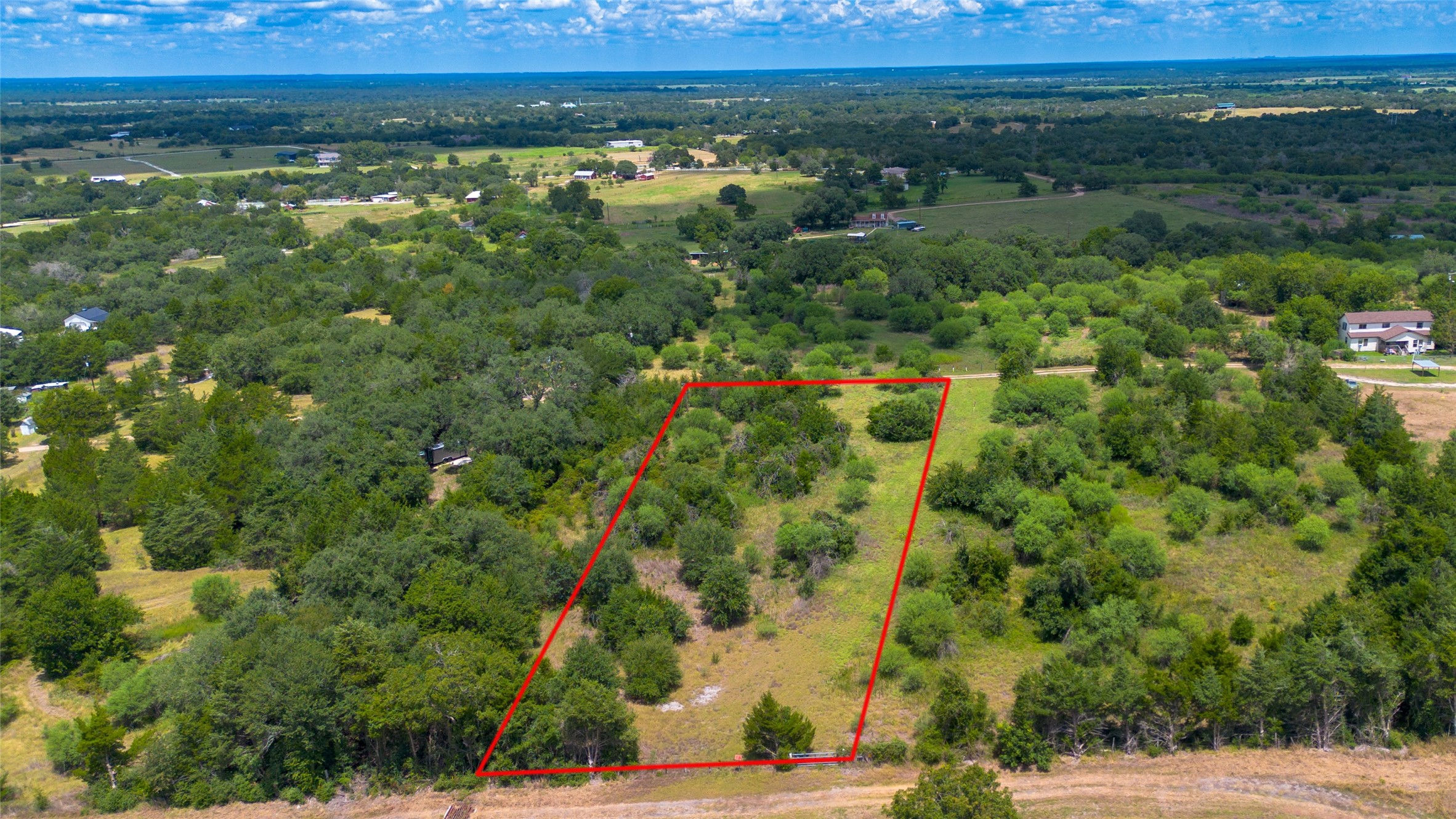 732 Christmas Road Brenham, TX 77833 - Photo 6 of 9 a view of a city with lush green forest