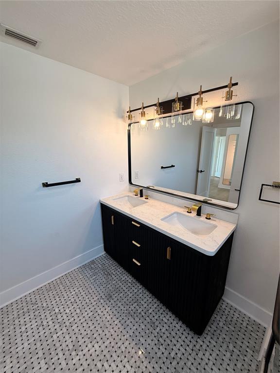 2729 West Union Street Tampa, FL 33607 - Photo 15 of 18 a bathroom with a sink vanity and mirror