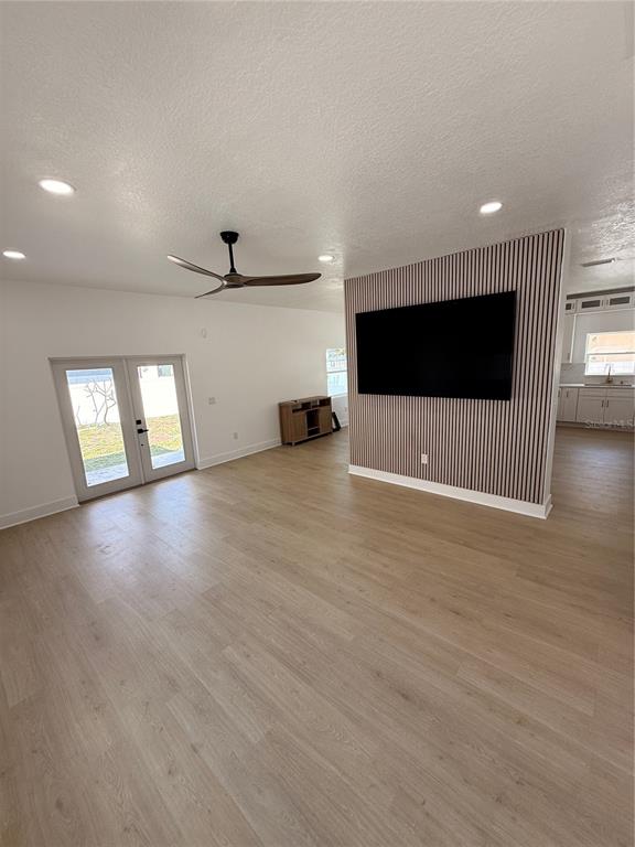 2729 West Union Street Tampa, FL 33607 - Photo 6 of 18 an empty room with wooden floor and windows
