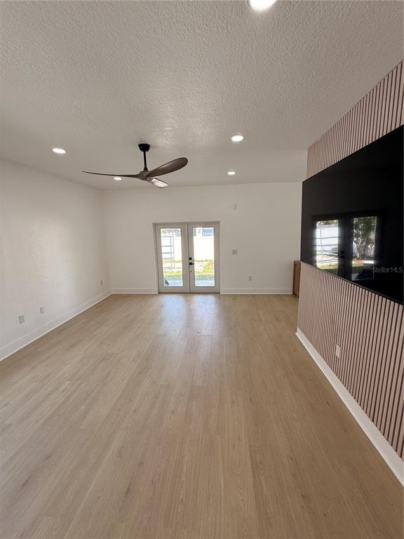 2729 West Union Street Tampa, FL 33607 - Photo 7 of 18 an empty room with wooden floor and windows