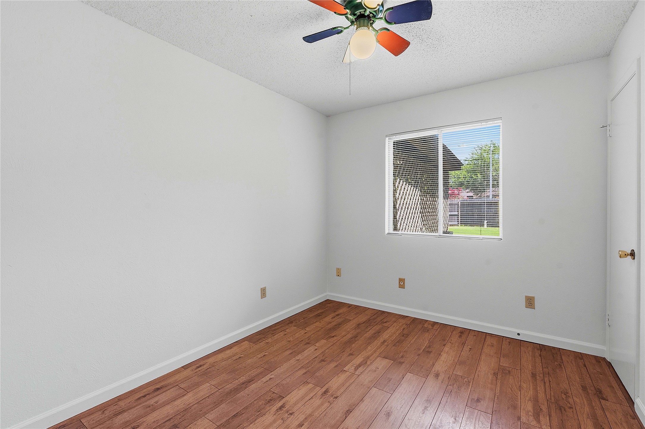 6205 Shadow Bend Austin, TX 78745 - Photo 23 of 31 Hardwood-style flooring extends across this bright, versatile bedroom, ready for personalization.