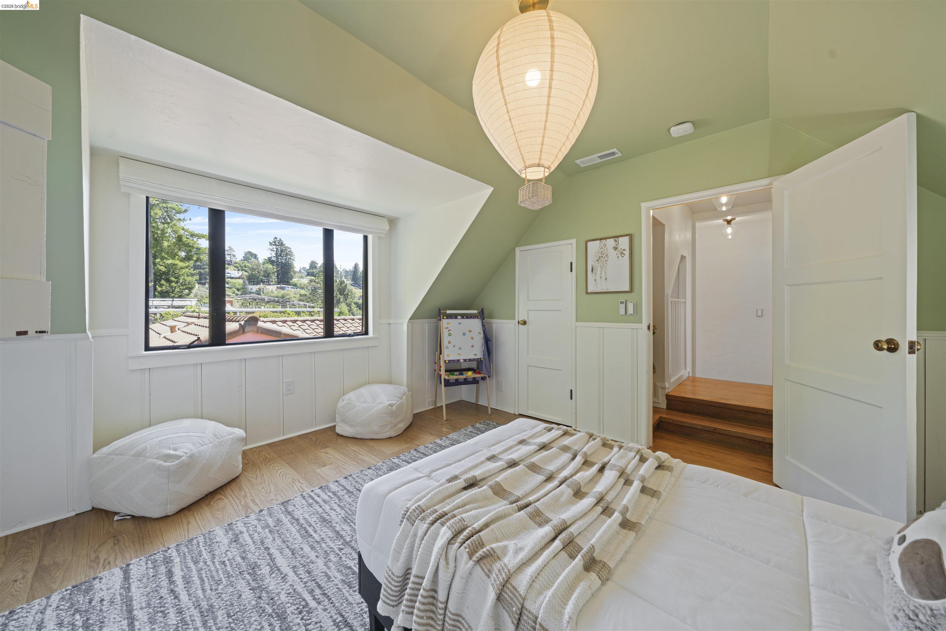 1170 Sterling Avenue Berkeley, CA 94708 - Photo 34 of 52 Bedroom with wood finished floors, wainscoting, and vaulted ceiling