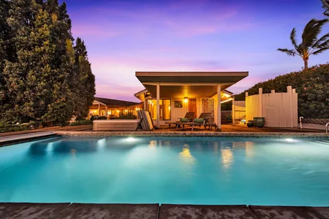 a view of a swimming pool with an outdoor space and seating area