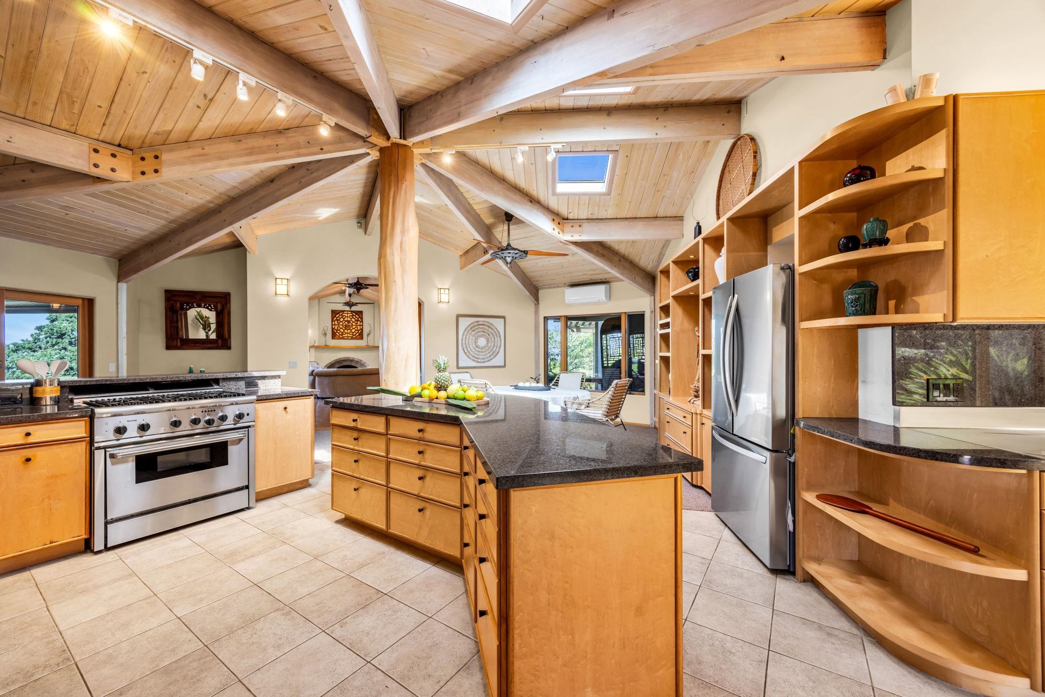 50 Poha Place Makawao, HI 96768 - Photo 13 of 50 a kitchen with stainless steel appliances granite countertop a stove and a refrigerator