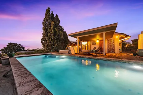 a view of swimming pool with chairs