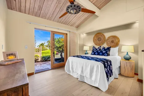 a bedroom with bed and wooden floor