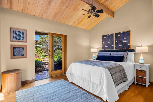a large bed sitting in a bedroom next to a window