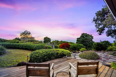 a view of a garden with sitting area