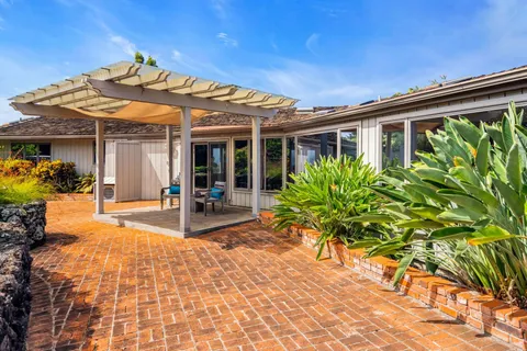 a view of a porch with furniture and floor to ceiling window