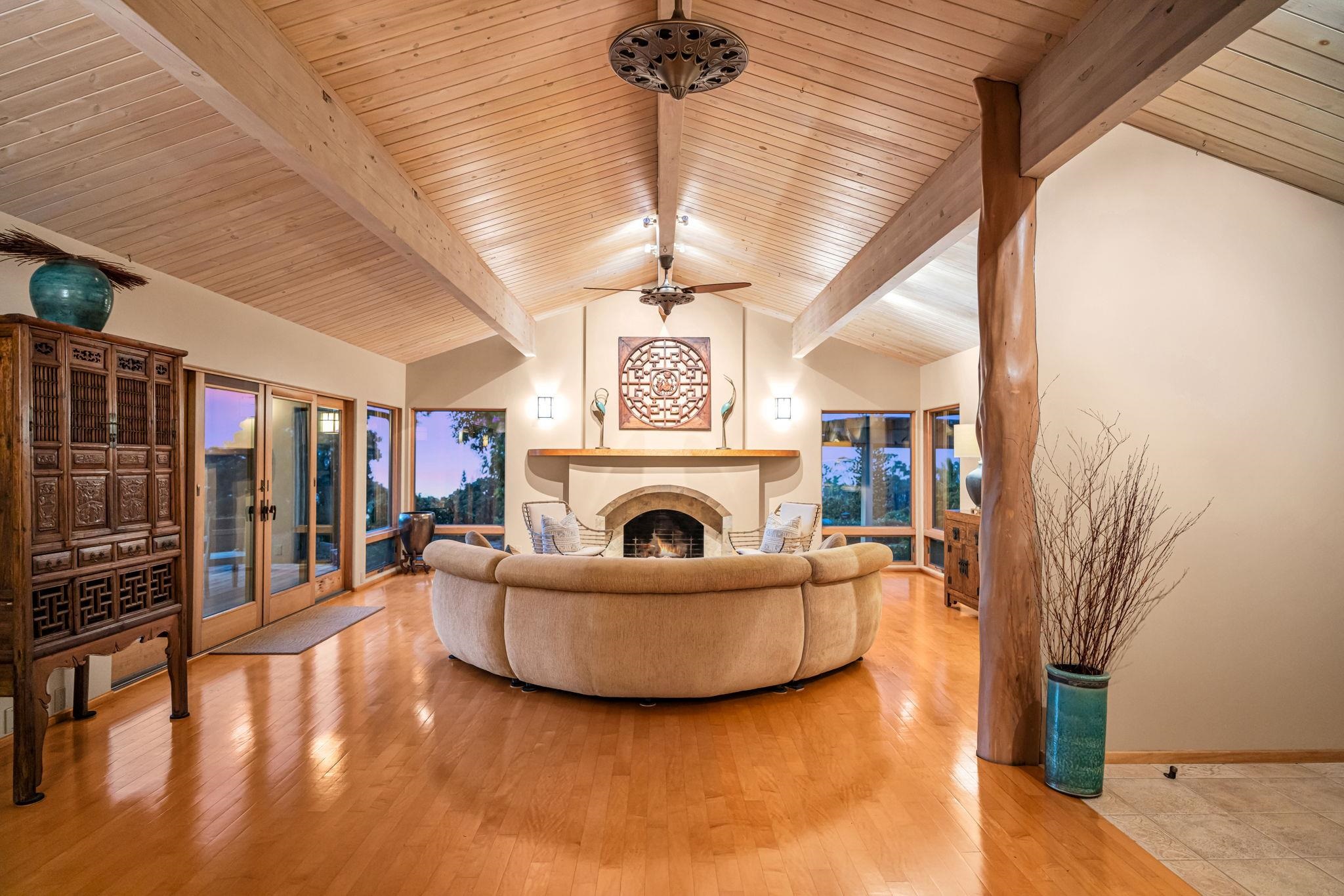50 Poha Place Makawao, HI 96768 - Photo 9 of 50 a living room with furniture a fireplace and a chandelier