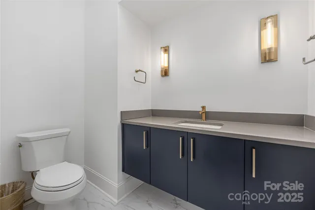 a bathroom with a sink a toilet and mirror