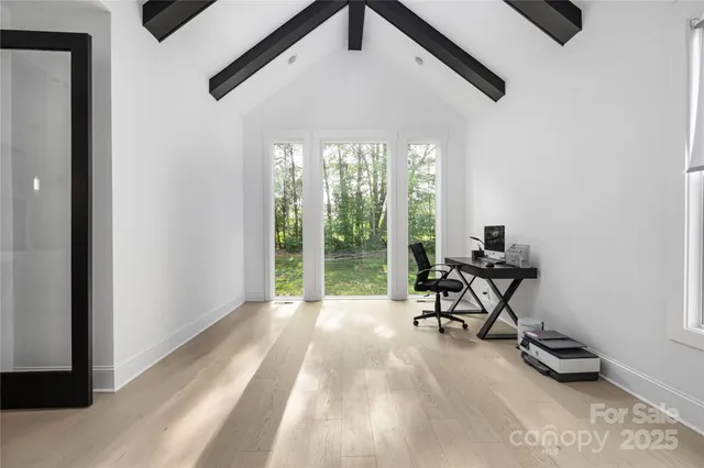 a view of a workspace with furniture and a window