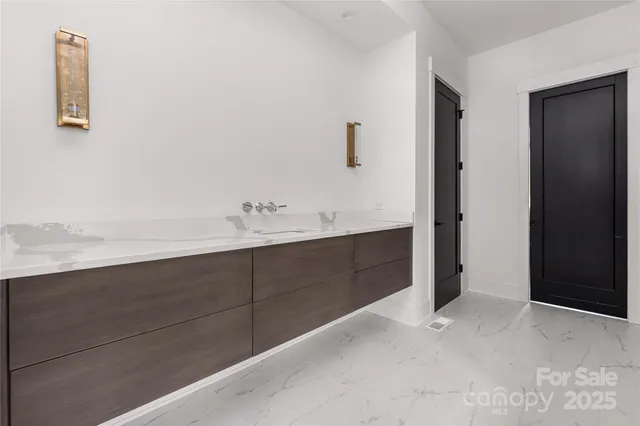 a bathroom with a sink vanity and tub