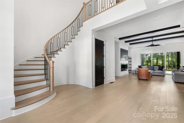 a view of a livingroom with furniture and a floor to ceiling window