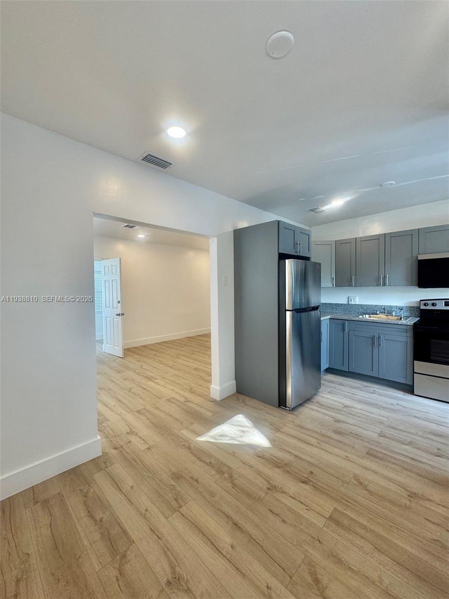 530 Northeast 71st Street, Unit 2 Miami, FL 33138 - Photo 12 of 22 a view of kitchen with wooden floor