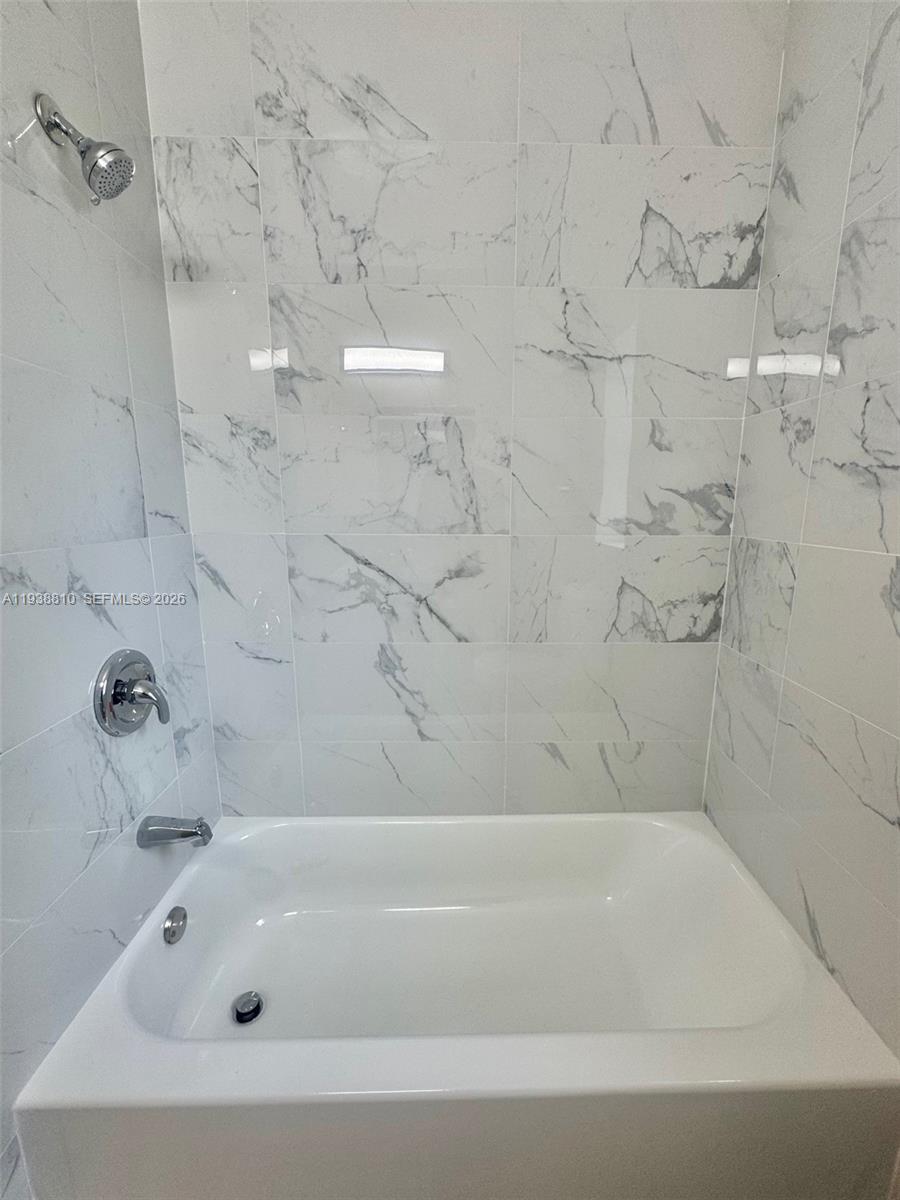 530 Northeast 71st Street, Unit 2 Miami, FL 33138 - Photo 16 of 22 a bathroom with a bathtub
