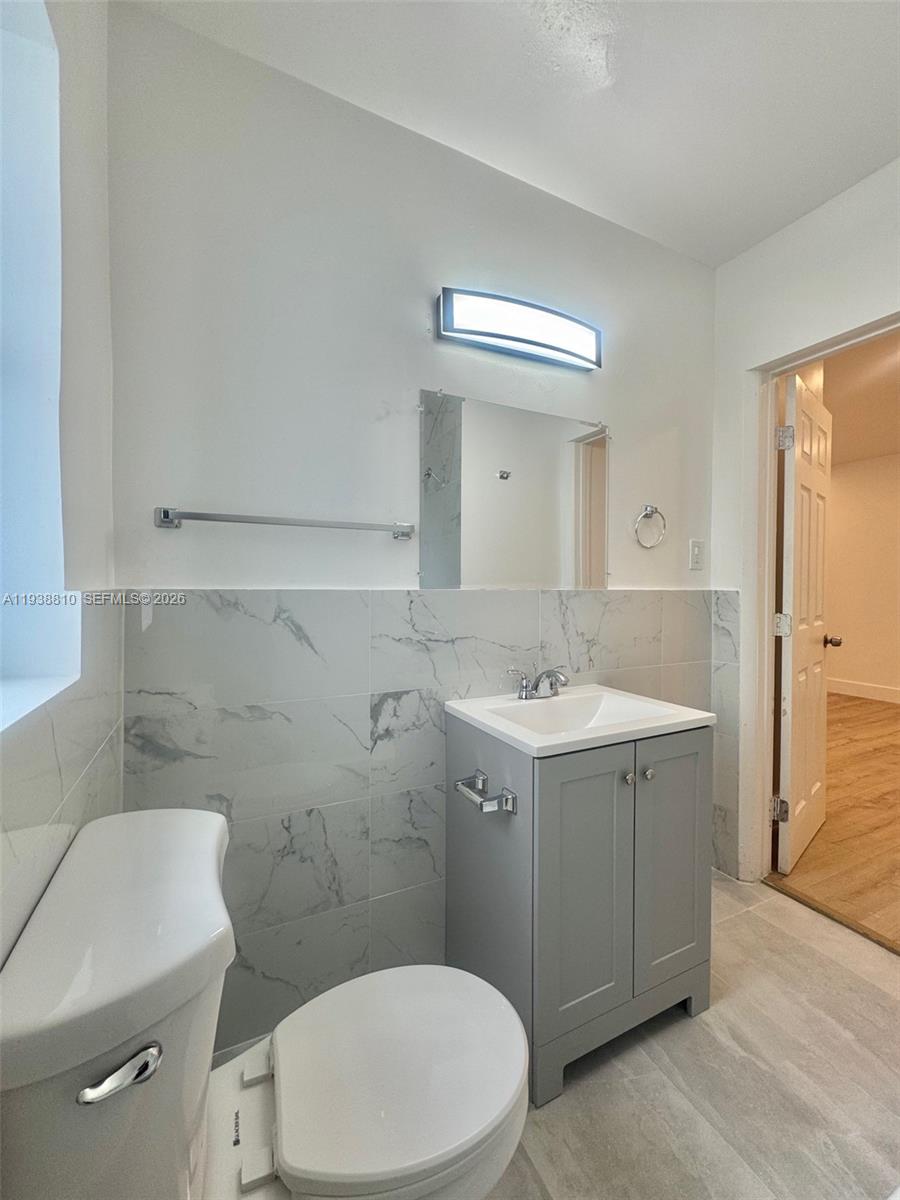 530 Northeast 71st Street, Unit 2 Miami, FL 33138 - Photo 6 of 22 a bathroom with a sink toilet and shower
